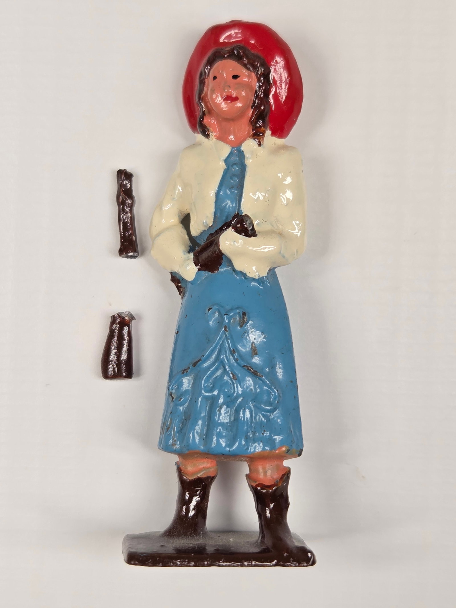 VINTAGE CRESCENT LEAD ANNIE OAKLEY: REMAINS IN FAIR CONDITION, SHOWING POSSIBLE REPAINT. GUN BROKEN W/ PIECES INCLUDED.