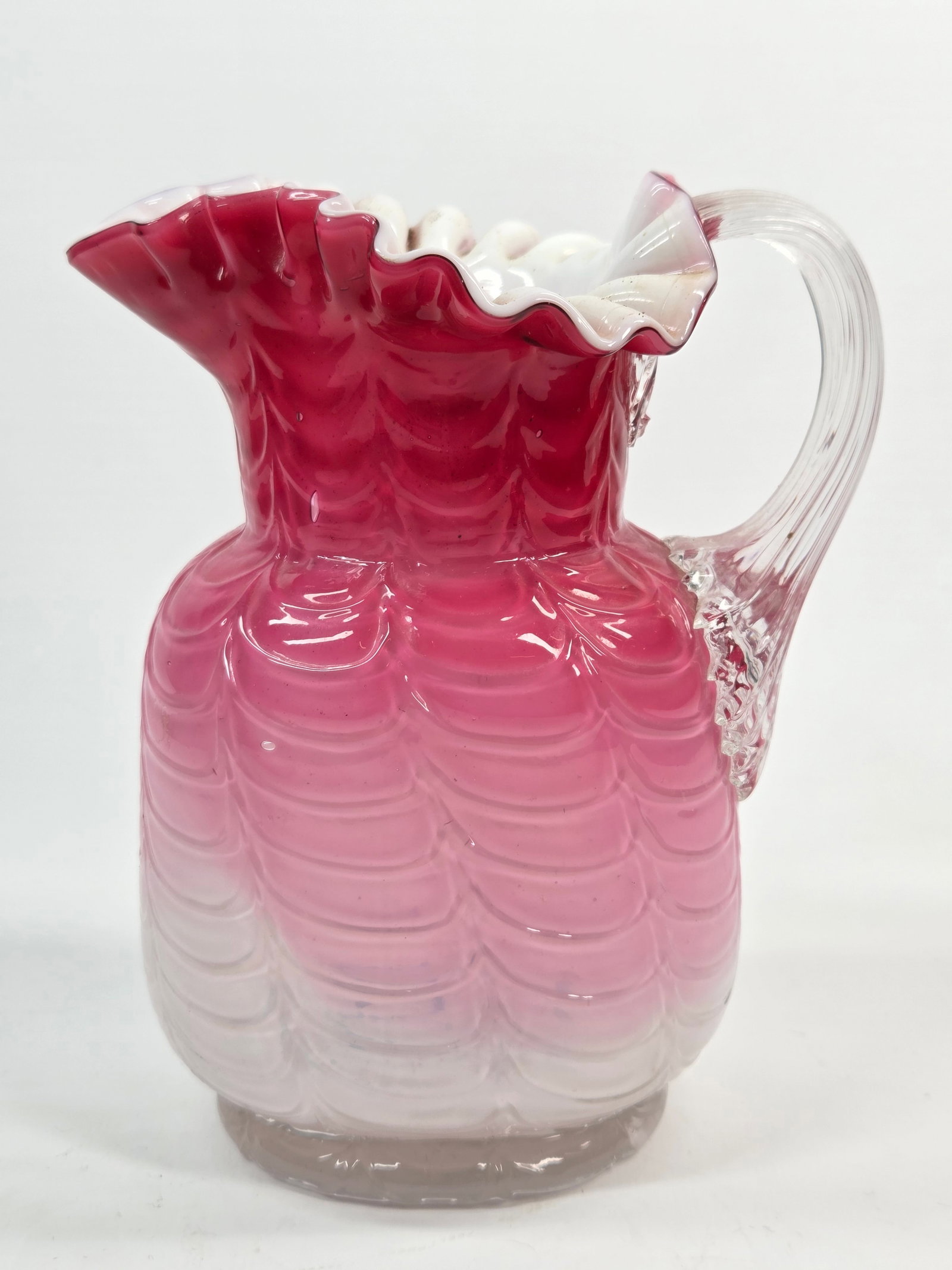 PHOENIX VICTORIAN DRAPE CASED GLASS CRANBERRY PITCHER: REMAINS IN GOOD CONDITION, SHOWING SOME TYPICAL WEAR. NO CHIPS OR CRACKS.
