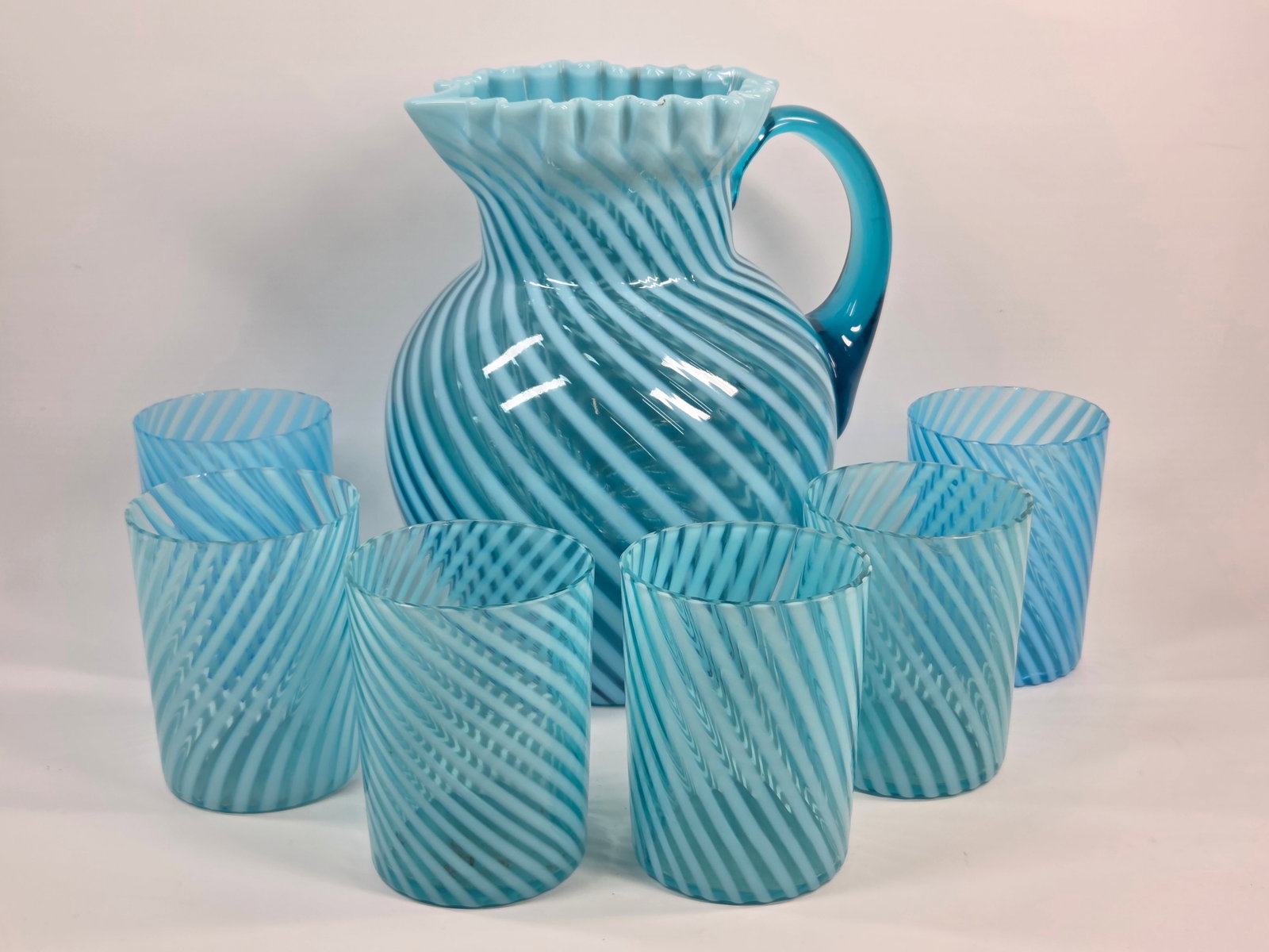 NORTHWOOD BLUE OPALESCENT "SWIRL" GLASS WATER SET: SET REMAINS IN VERY GOOD CONDITION, SHOWING SOME TYPICAL USAGE WEAR. NO CHIPS OR CRACKS.