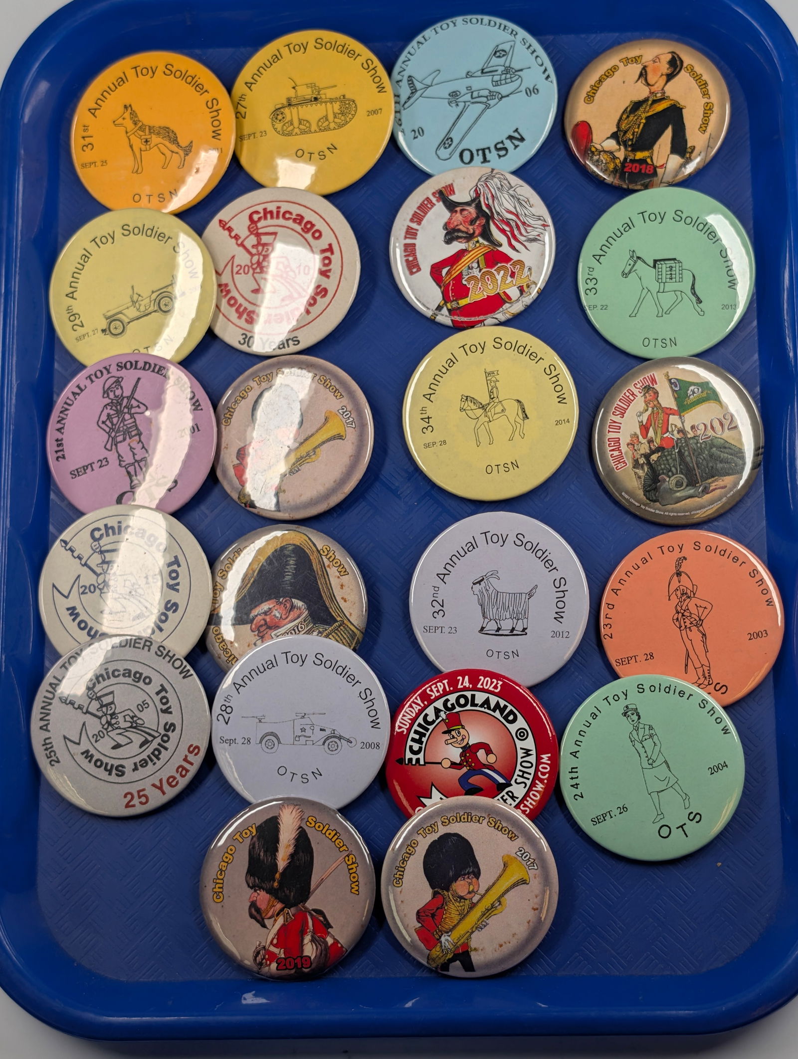 22) ANNUAL TOY SOLDIER SHOW PINS: ALL REMAIN IN GOOD CONDITION.