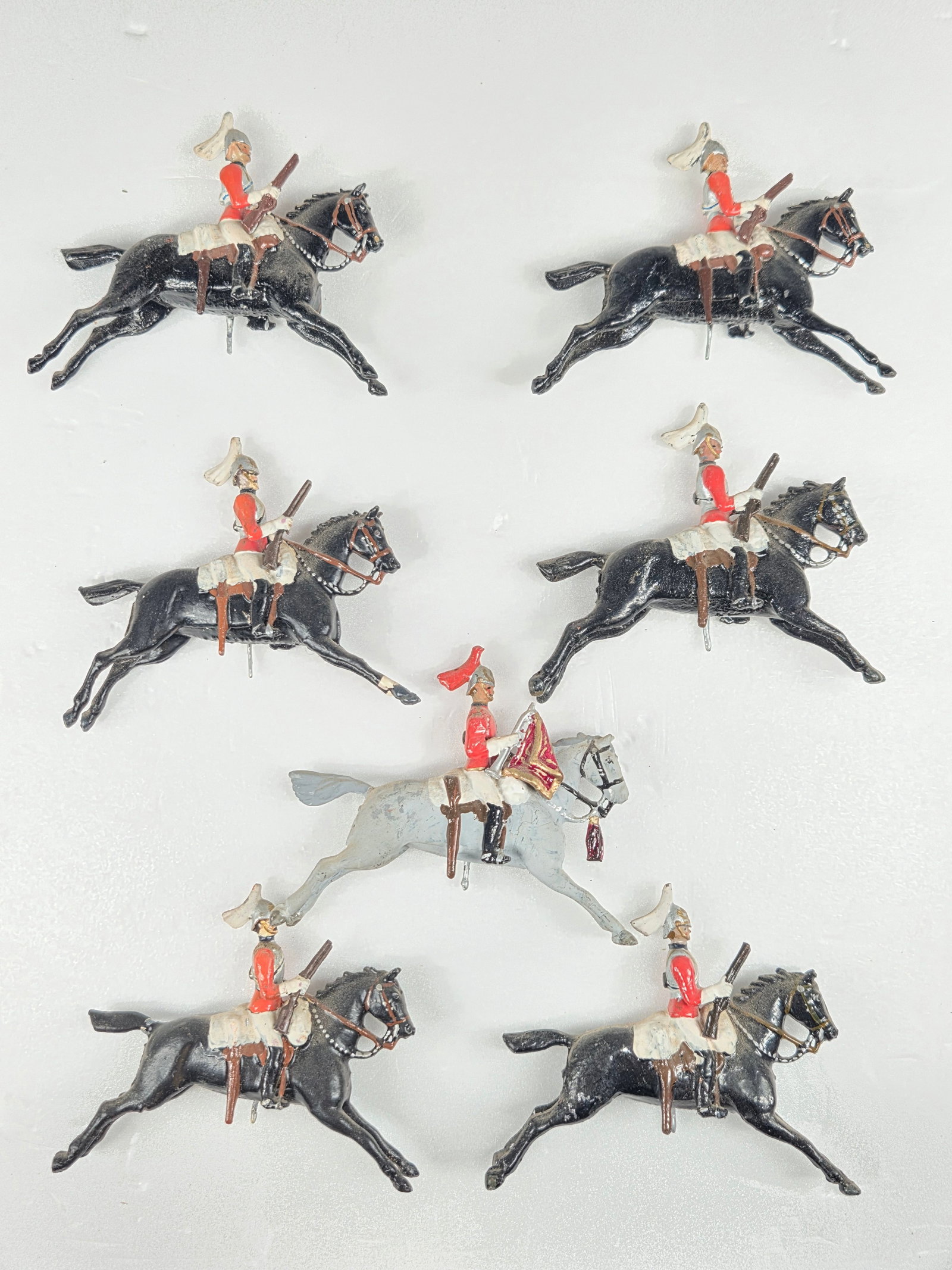 SET OF 7 VINTAGE BRITAIN MOUNTED SOLDIERS: ALL REMAIN IN GOOD CONDITION, SHOWING SOME TYPICAL WEAR. DUSTY, NEEDING CLEANED.
