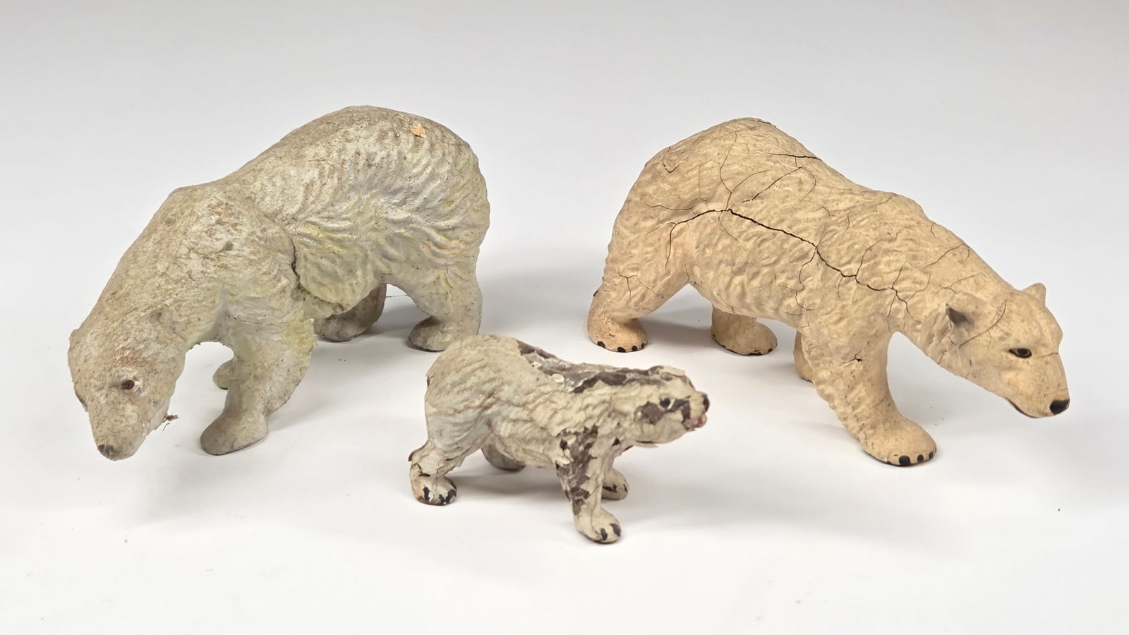 3) ANTIQUE GERMAN COMPOSITION POLAR BEARS: ALL REMAIN IN FAIR CONDITION, SHOWING CRACKS.
