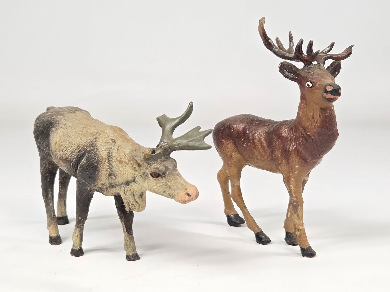 2) ANTIQUE GERMAN COMPOSITION REINDEER: BOTH REMAIN IN GOOD CONDITION, ONE WITH BROKEN MISSING ANTLER