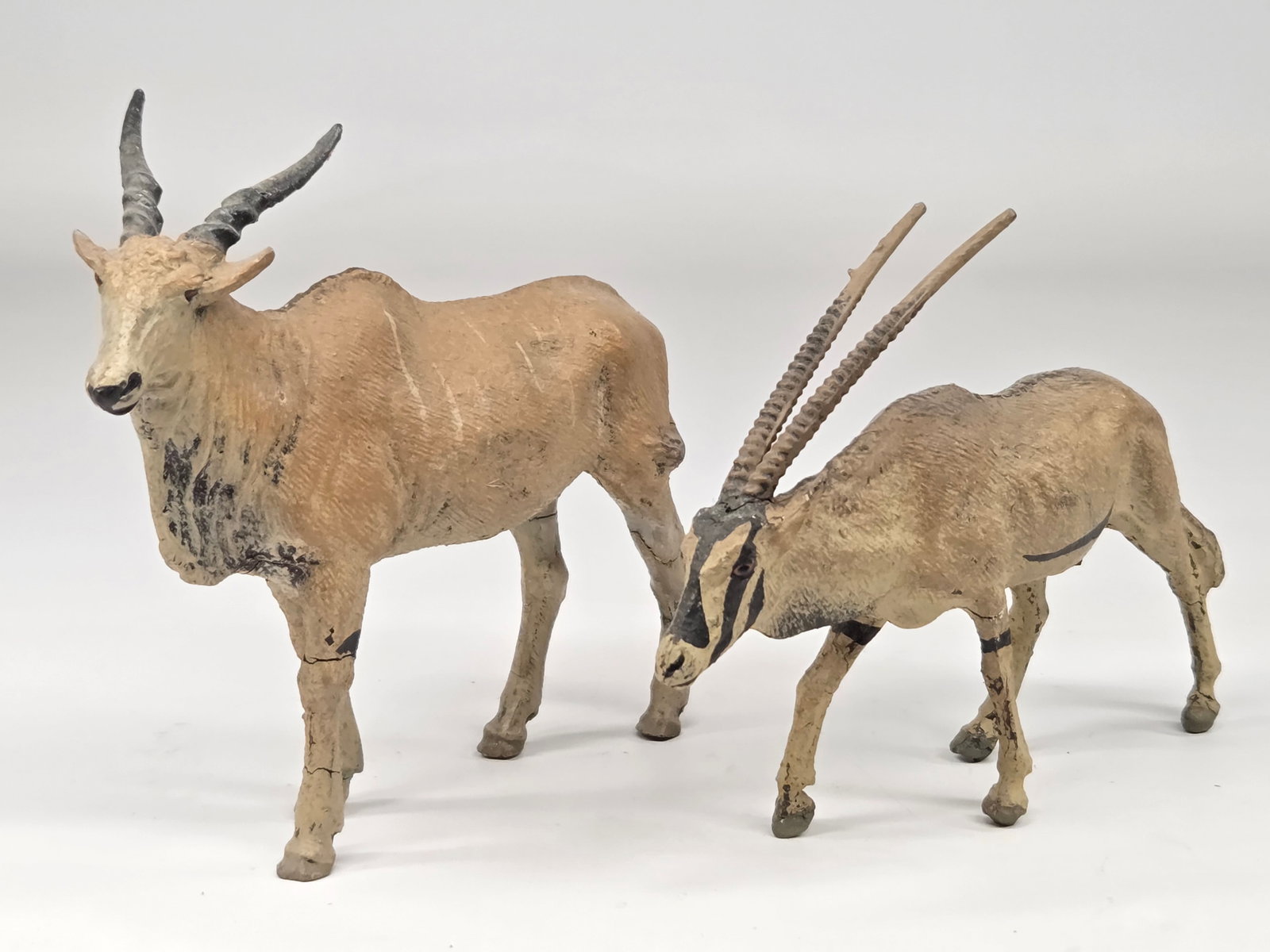 2) ANTIQUE GERMAN COMPOSITION ANIMALS: BOTH REMAIN IN GOOD CONDITION, SHOWING SOME TYPICAL WEAR / CRACKING TO LEGS.