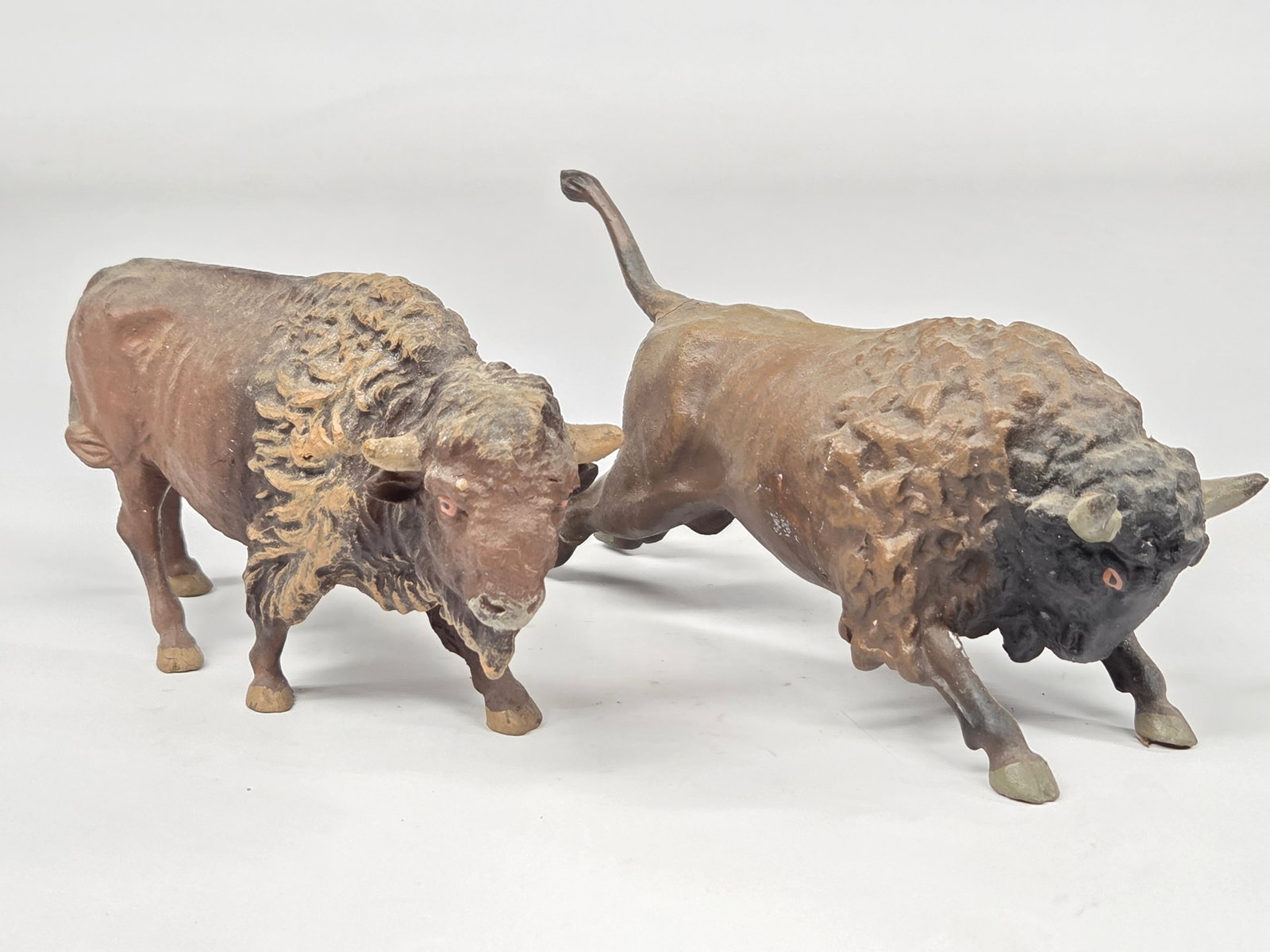 2) ANTIQUE GERMAN COMPOSITION BUFFALO: BOTH REMAIN IN GOOD CONDITION, SHOWING SOME TYPICAL WEAR.