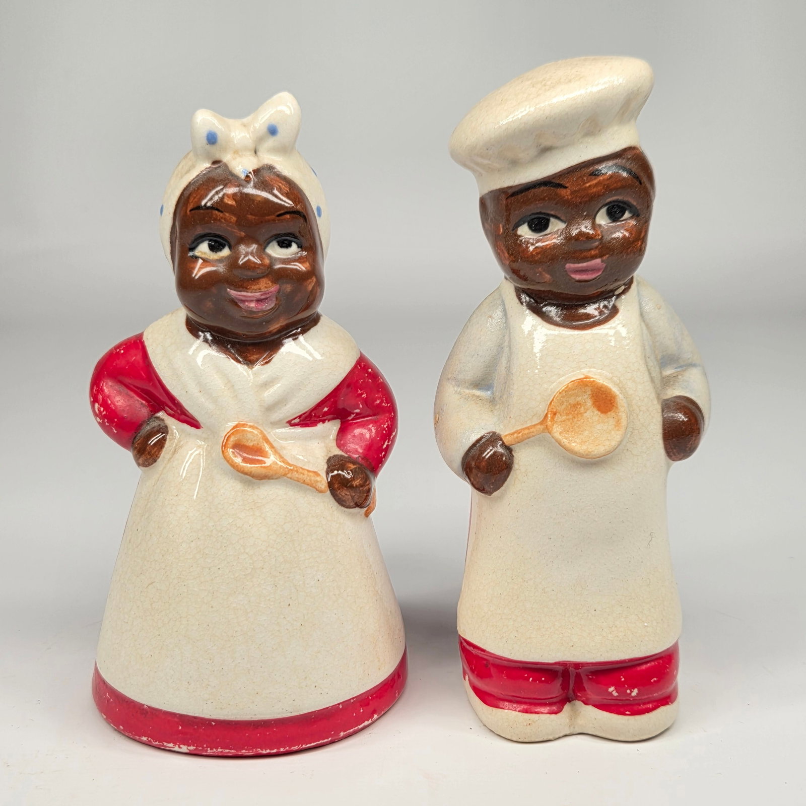 VINTAGE JAPAN BLACK AMERICAN SALT & PEPPER SET: PAIR REMAINS IN GOOD CONDITION. BOTH SHOW SOME YELLOWING AND CRAZING.