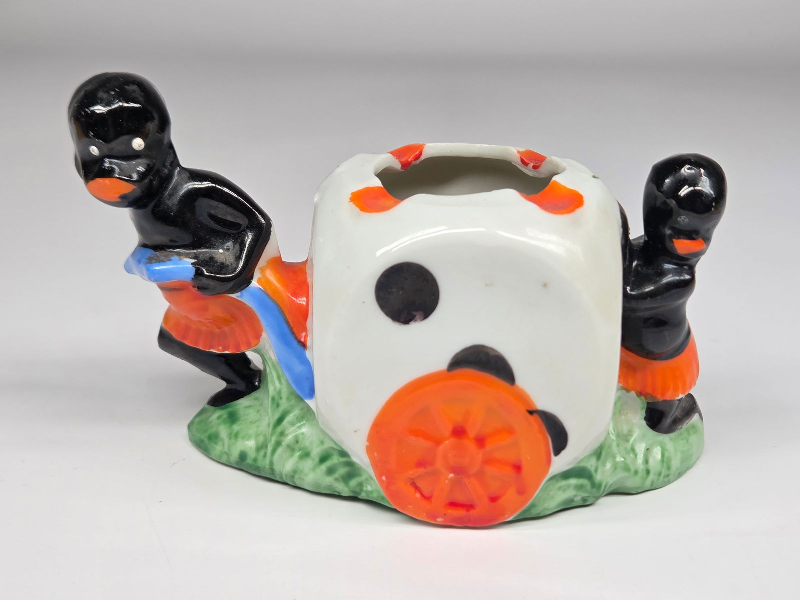 JAPAN BISQUE BLACK AMERICANA DICE CART ASHTRAY: REMAINS IN GOOD CONDITION. NO CHIPS OR CRACKS.