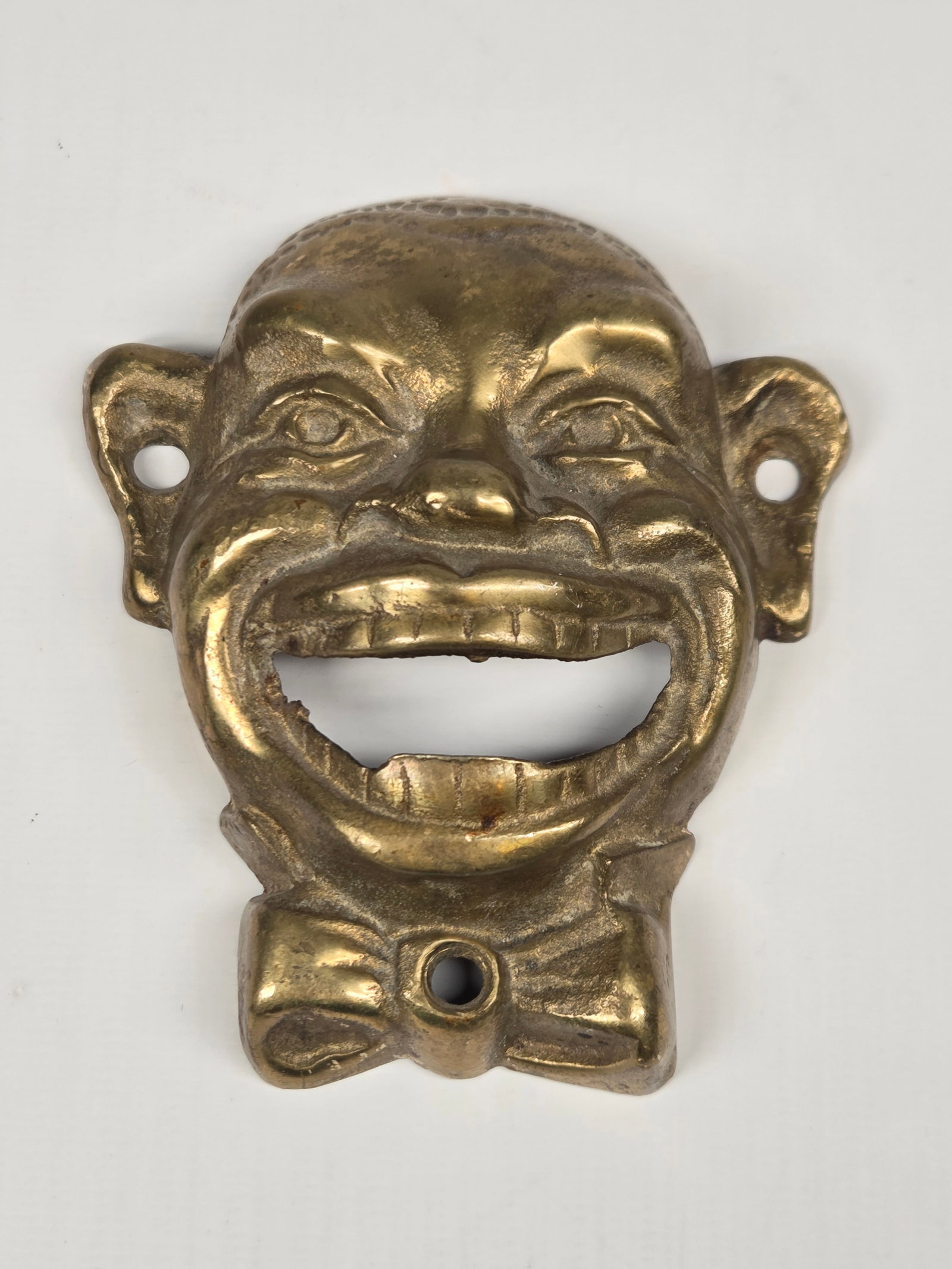 BRASS BLACK AMERICANA BOTTLE OPENER: REMAINS IN GOOD CONDITION, SHOWING SOME TYPICAL WEAR.