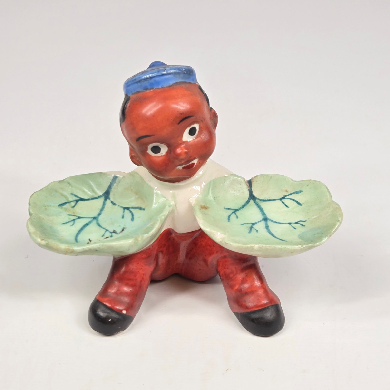 JAPAN CERAMIC BLACK AMERICANA SHAKER STAND: REMAINS IN GOOD CONDITION, SHOWING SOME TYPICAL WEAR. NO CHIPS OR CRACKS.