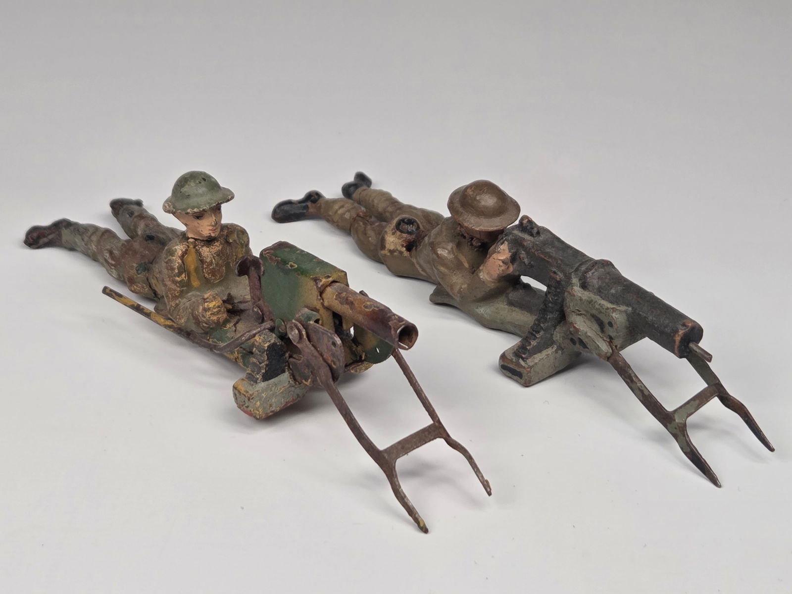 2) LINEOL GERMAN COMPOSITION MACHINE GUNNERS: BOTH REMAIN IN FAIR CONDITION, SHOWING WEAR WITH CRACKS.