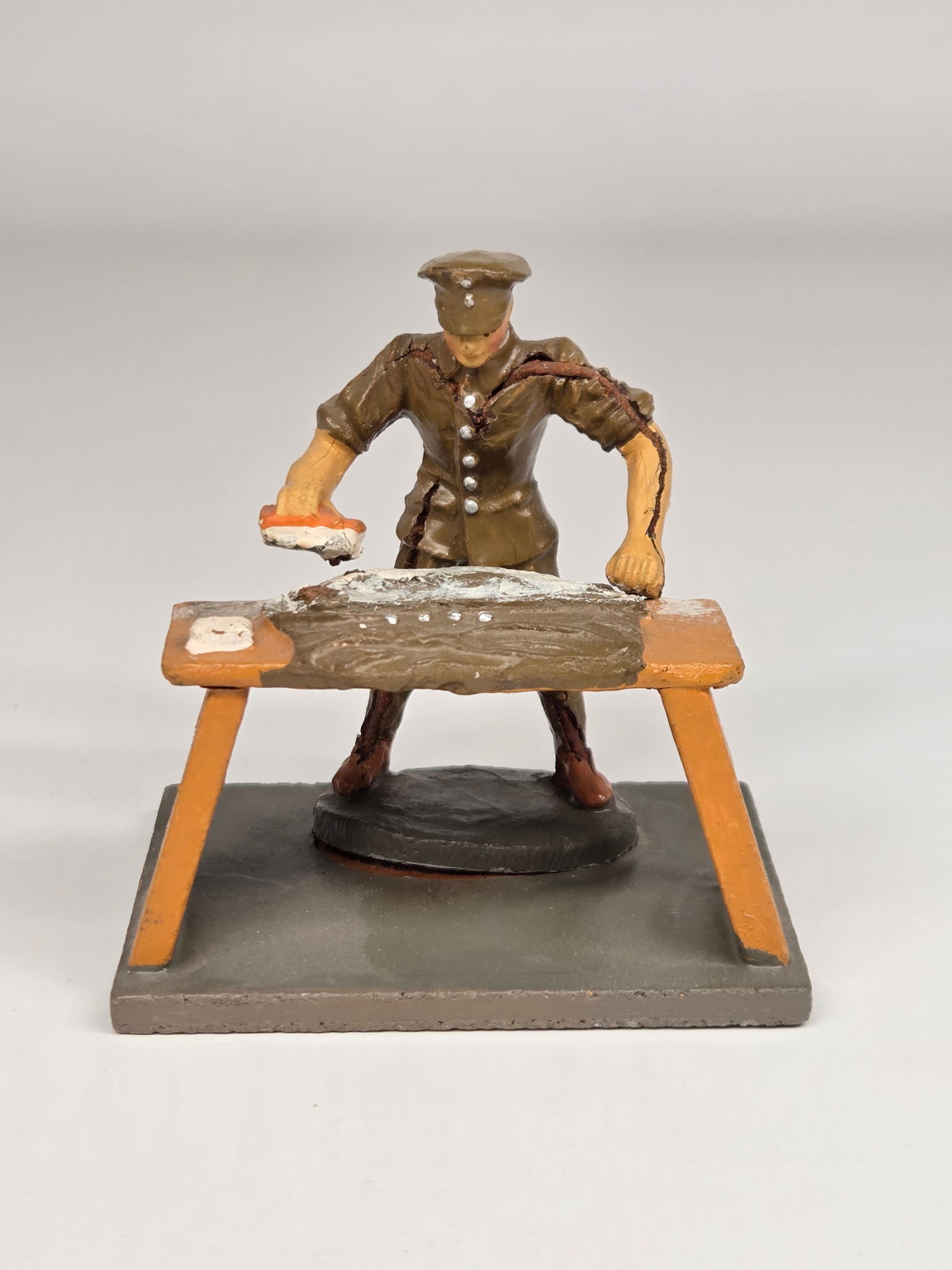 GERMAN ELASTOLIN SOLDIER WASHING UNIFORM: REMAINS IN GOOD CONDITION. SOLDIER WITH CRACKING IN BODY AND SEPARATED FROM BASE.