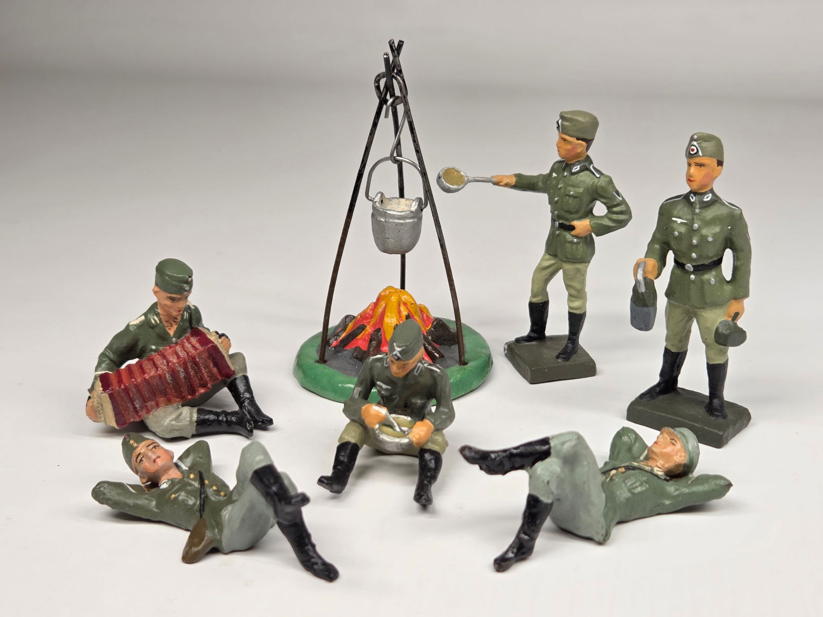 GERMAN ELASTOLIN COMPOSITION CAMP FIRE CREW: ALL REMAIN IN GOOD CONDITION, SHOWING SOME TYPICAL WEAR.