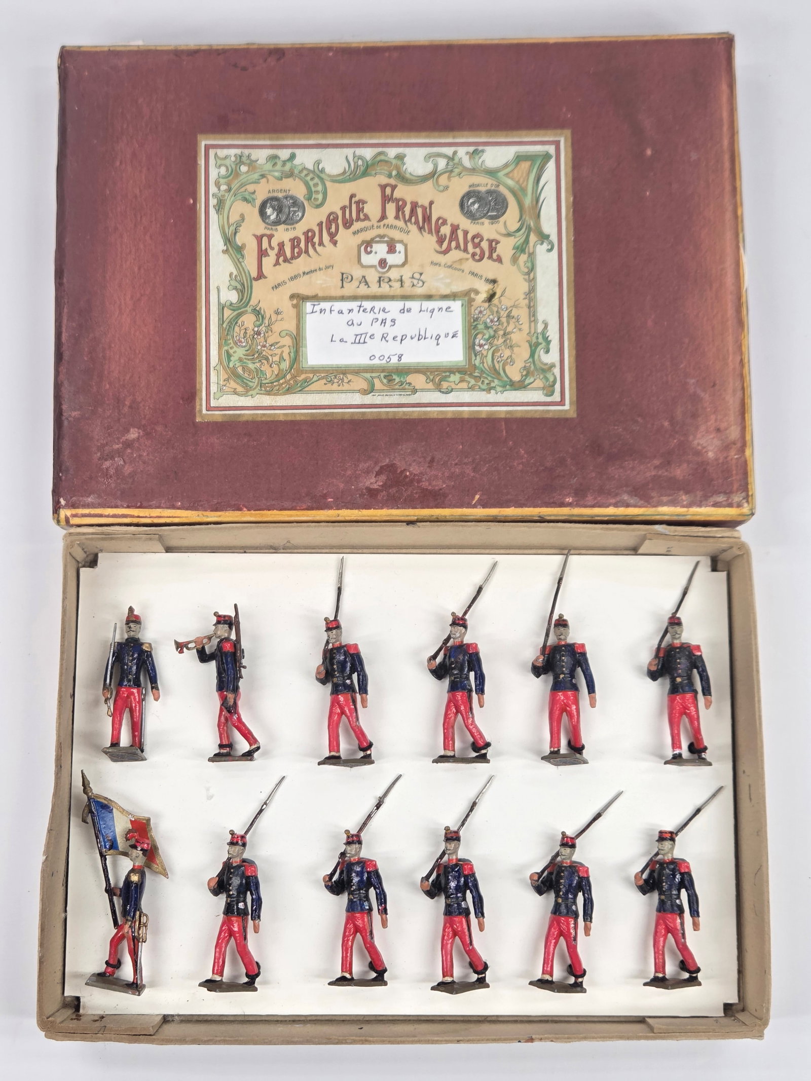 C.B.G. HAND PAINTED 12-PIECE INFANTRY SOLDIER SET: SET REMAINS IN GOOD CONDITION. BOX SHOWING SOME WEAR. INSERT CUSTOM.
