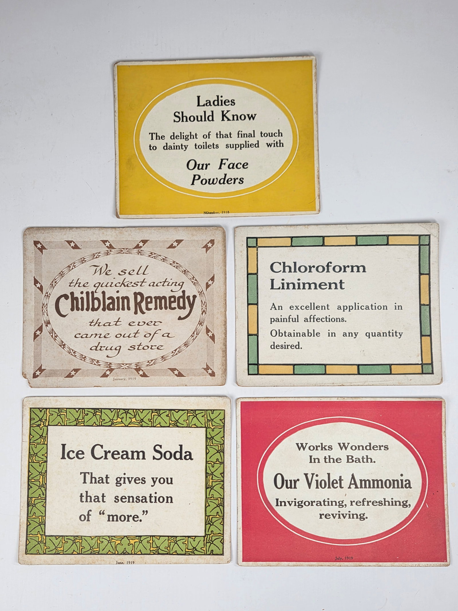 5) 1919 CARDBOARD STORE DISPLAY SIGNS: ALL REMAIN IN GOOD CONDITION, SHOWING SOME TYPICAL WEAR.