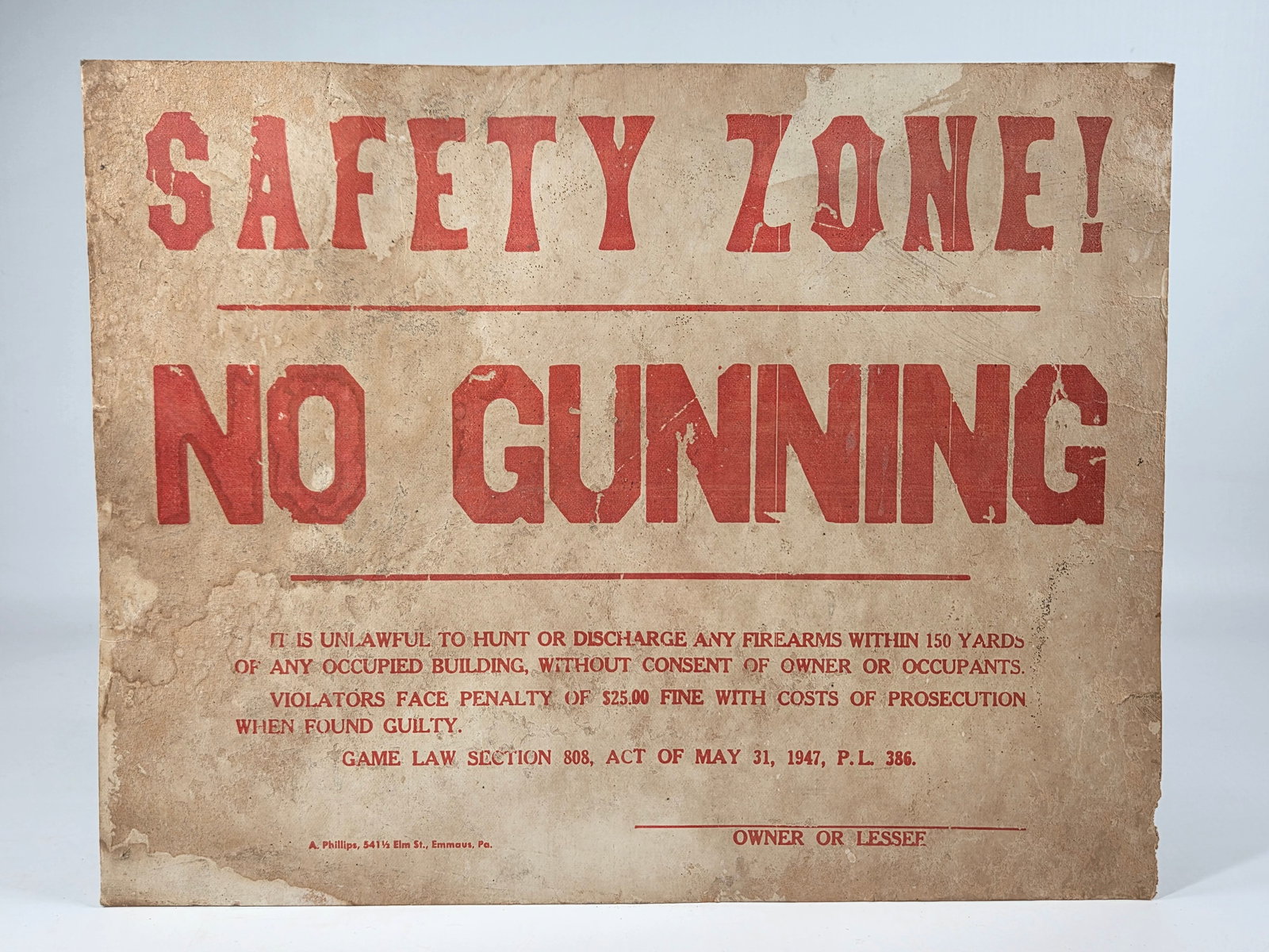 SAFETY ZONE! NO GUNNING CARDBOARD SIGN: REMAINS IN FAIR TO GOOD CONDITION, SHOWING SOME TYPICAL WEAR.