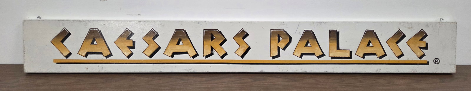 CAESARS PALACE WOOD CASINO SIGN: REMAINS IN GOOD CONDITION, SHOWING SOME TYPICAL WEAR.