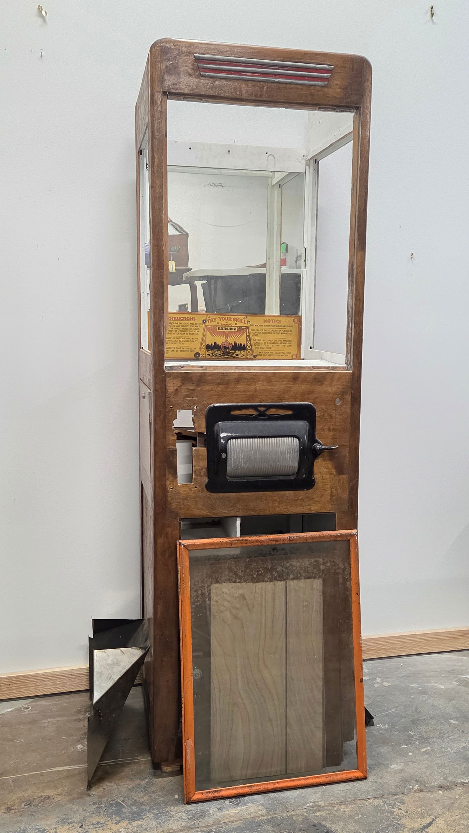 ANTIQUE ELECTRIC-HOIST SKILL GAME PARTS CABINET: PARTS CONDITION CABINET, SHOWING WEAR THROUGHOUT. MISSING PIECES. **PLEASE NOTE** THIS ITEM IS NOT AVAILABLE FOR SHIPPING. PICKUP ONLY PLEASE.