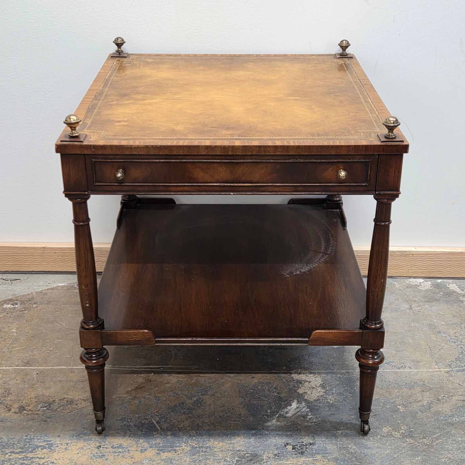VINTAGE LEATHER TOP END TABLE W/ CASTORS: REMAINS IN GOOD CONDITION, SHOWING SOME TYPICAL USAGE WEAR. LEATHER HAS A WEAR SPOT IN CORNER. **PLEASE NOTE** THIS ITEM IS NOT AVAILABLE FOR SHIPPING. LOCAL PICKUP ONLY PLEASE.