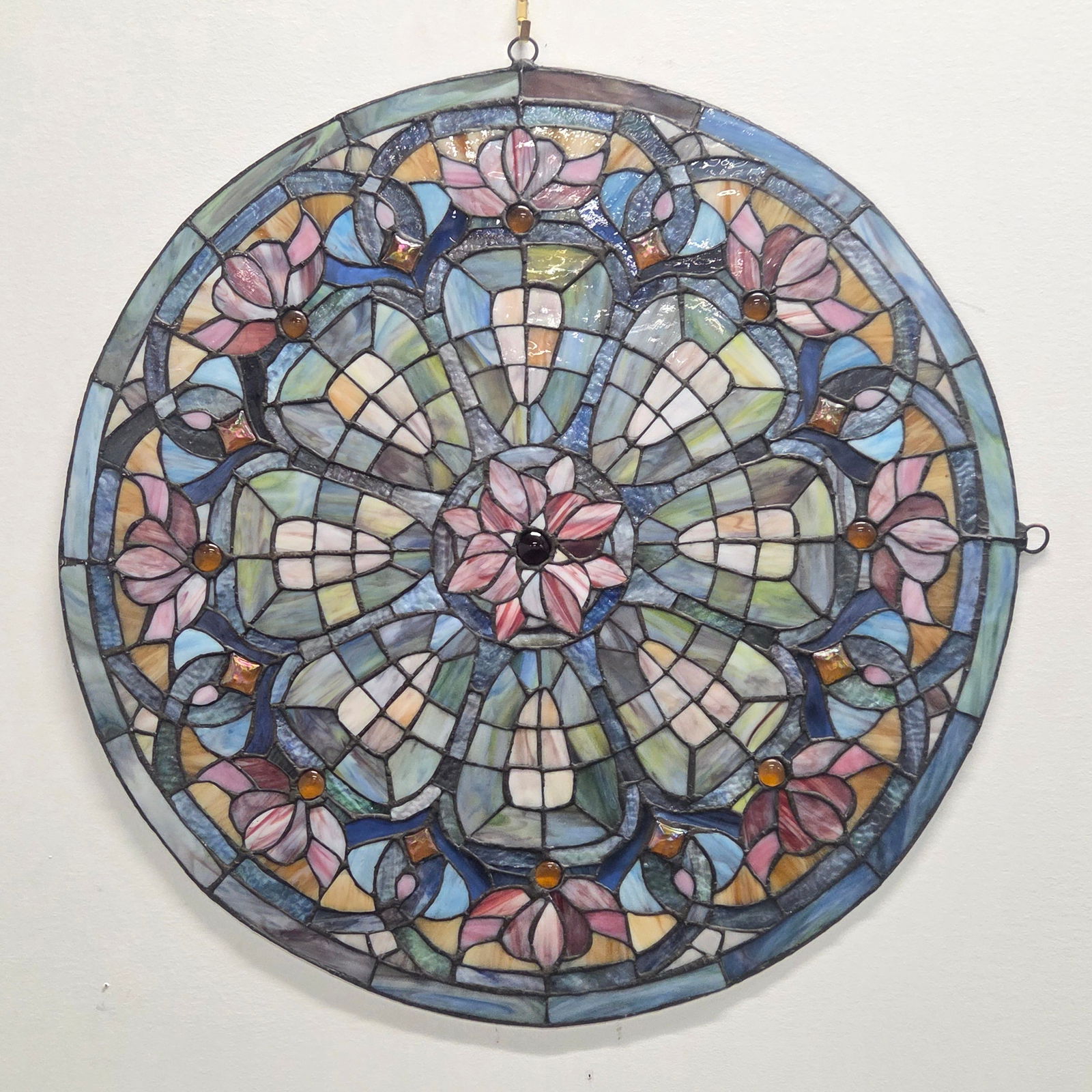 ROUND GEOMETRIC LEADED STAINED GLASS WINDOW: REMAINS IN GOOD CONDITION, SHOWING SOME TYPICAL WEAR.