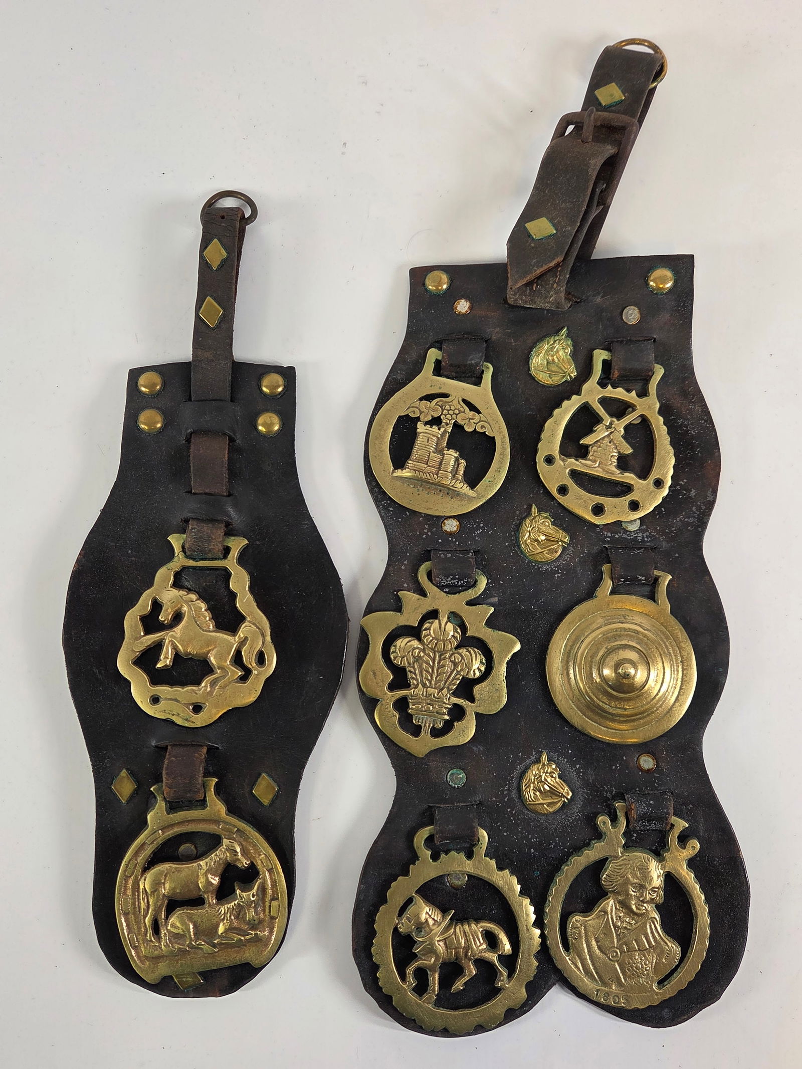 PAIR OF BRASS & LEATHER DECORATIVE MEDALS: BOTH REMAIN IN GOOD CONDITION, SHOWINGS OME TYPICAL WEAR TO LEATHER.