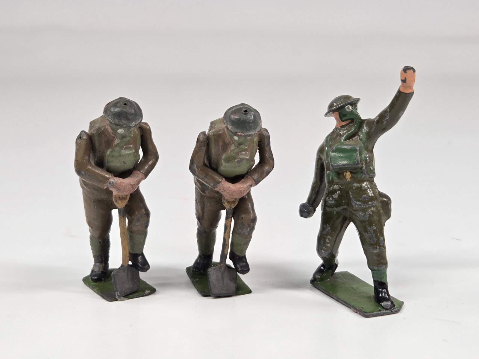 3) VINTAGE BRITAINS SOLDIERS IN ACTION: ALL REMAIN IN FAIR TO GOOD CONDITION, SHOWING TYPICAL WEAR.