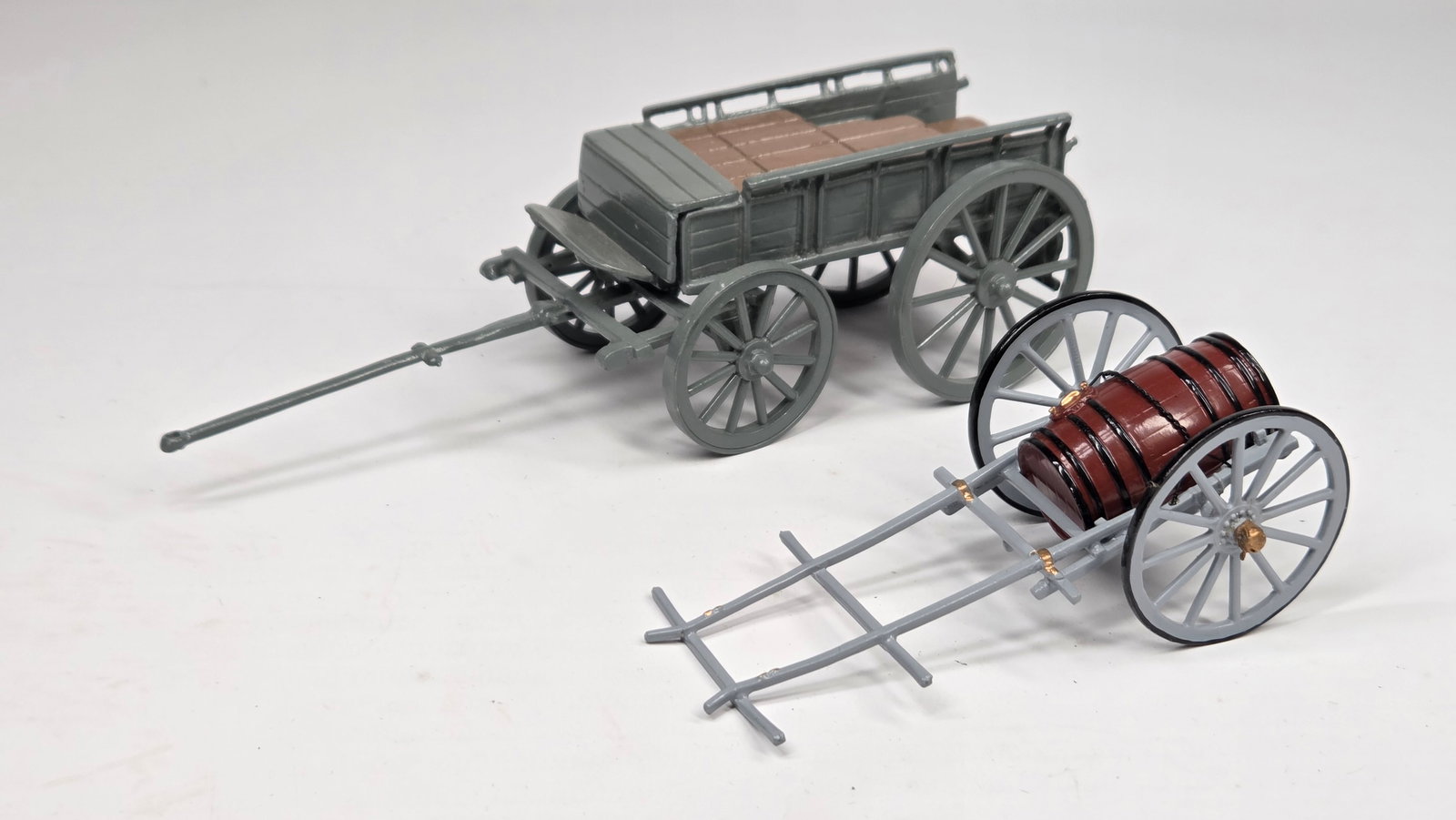 CLH LEAD HAND PAINTED AMMO WAGON & BARREL WAGON: BOTH REMAIN IN VERY GOOD CONDITION, SHOWING MINIMAL WEAR.