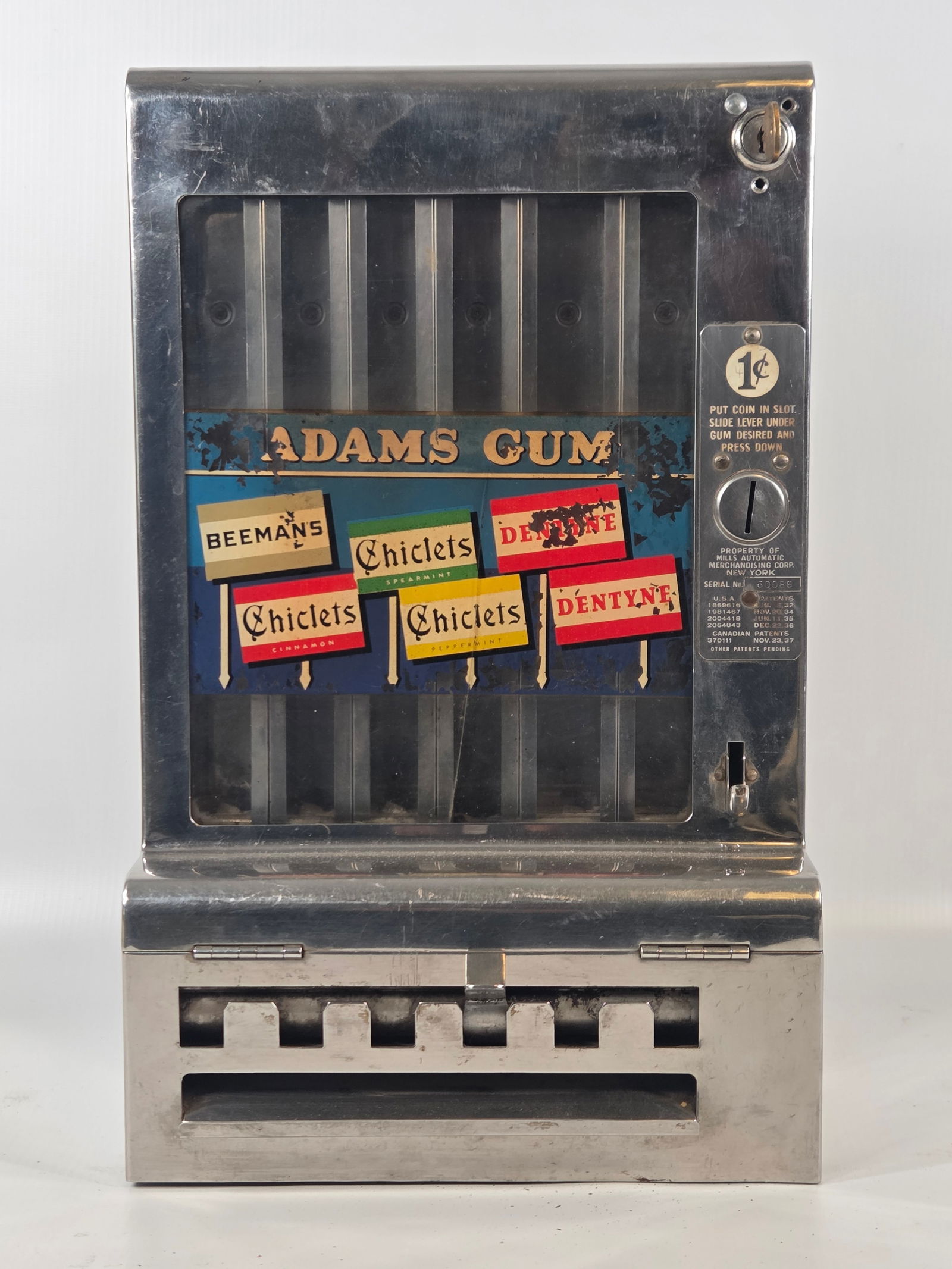 MILLS ADAMS GUM 1 CENT CHEWING GUM VENDING MACHINE: REMAINS IN GOOD CONDITION, SHOWING TYPICAL USAGE WEAR. CRACKING IN GLASS AND PAINT WEAR. KEY INCLUDED.