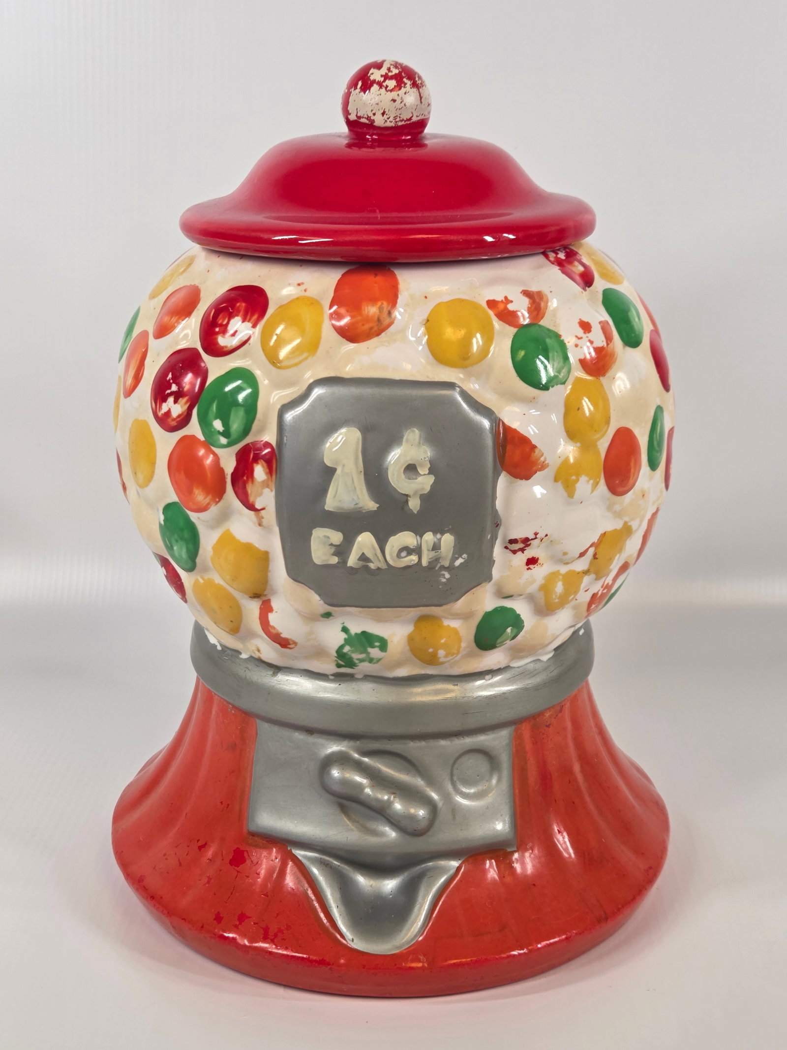 HOMEMADE CERAMIC GUMBALL MACHINE COOKIE JAR: REMAINS IN FAIR TO GOOD CONDITION, SHOWING SOME TYPICAL USAGE WEAR. SMALL CHIP ALONG EDGE. PAINT WORN.