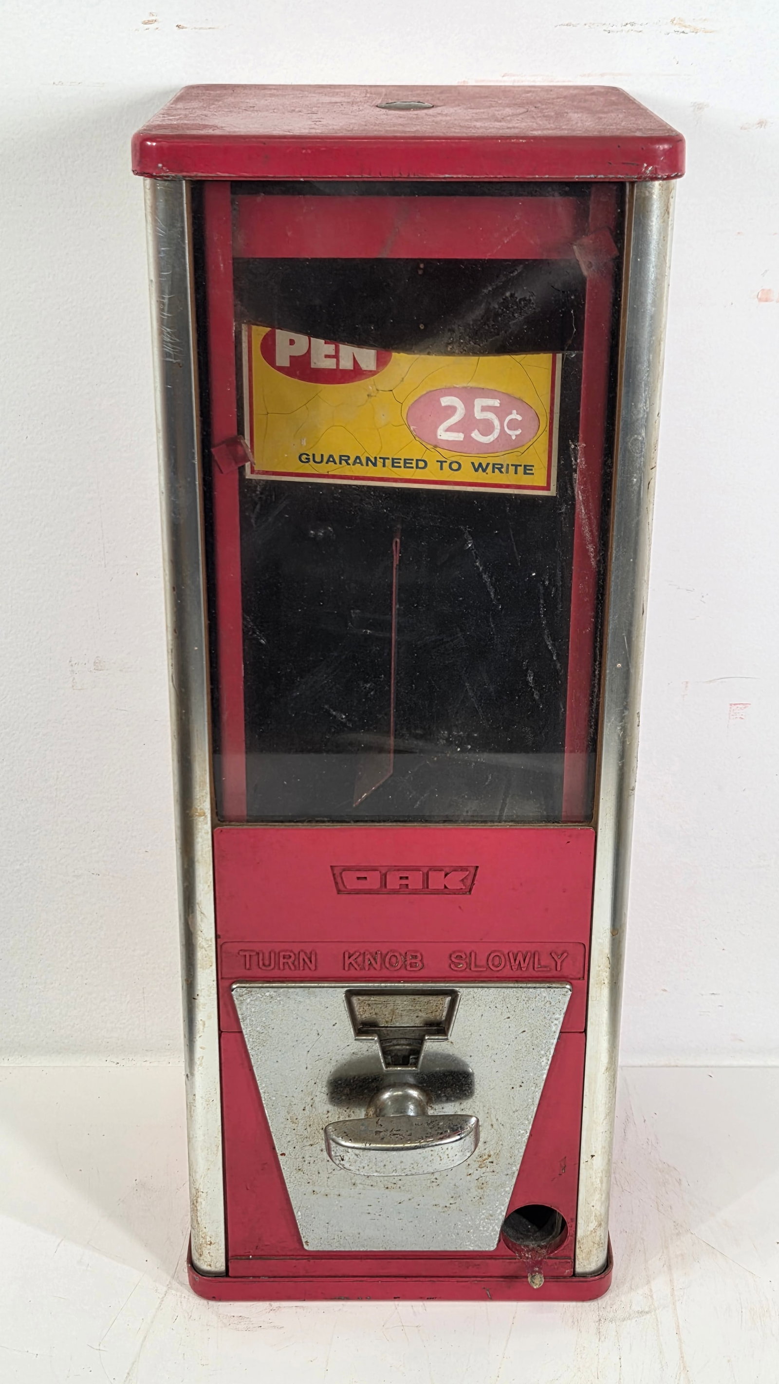 VINTAGE OAK 25 CENT PEN VENDING MACHINE: REMAINS IN GOOD CONDITION, SHOWING TYPICAL USAGE WEAR.