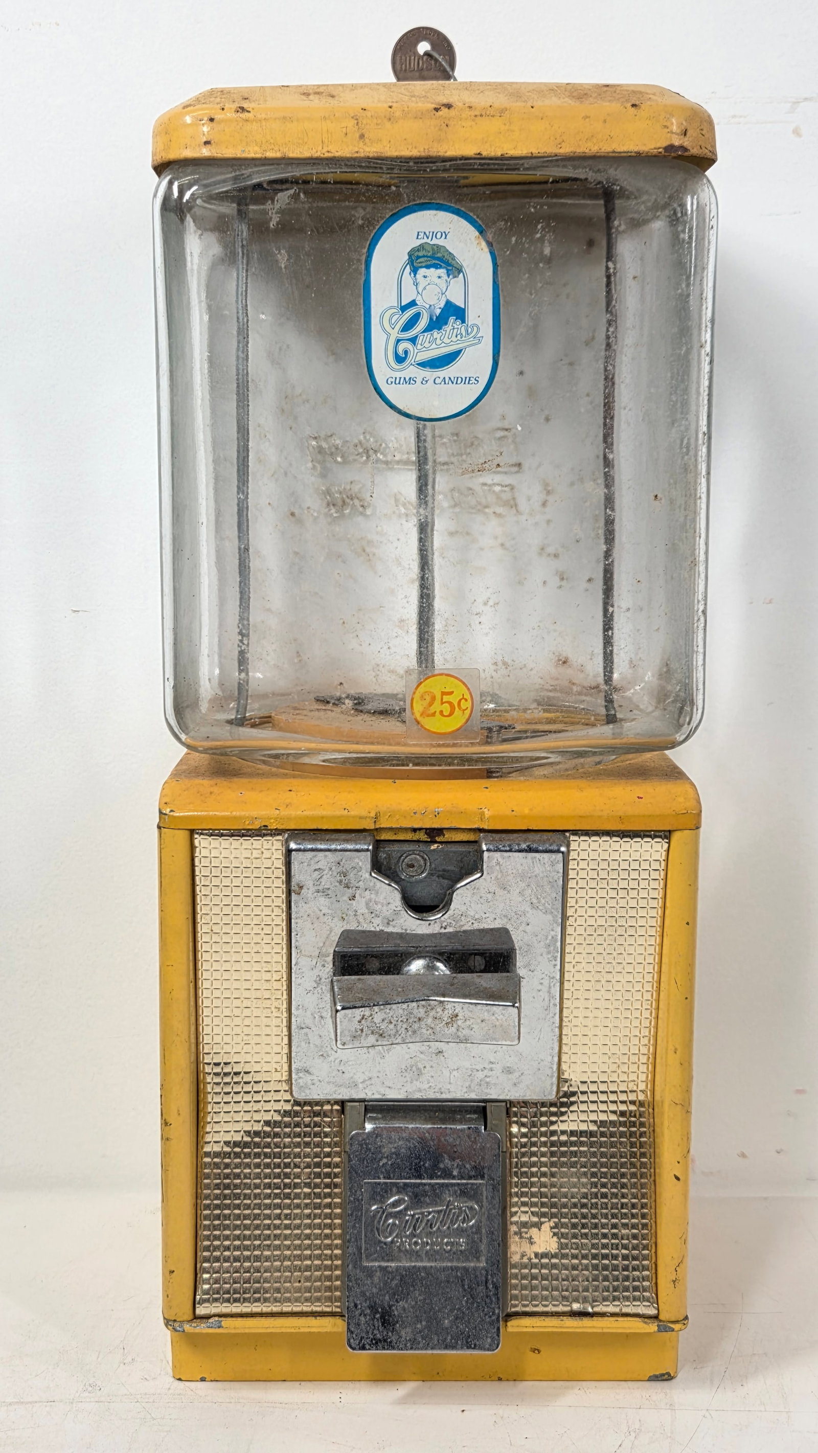 YELLOW CURTIS GUM & CANDIES 25 CENT VENDING MACHINE: REMAINS IN FAIR CONDITION, SHOWING USAGE WEAR THROUGHOUT.