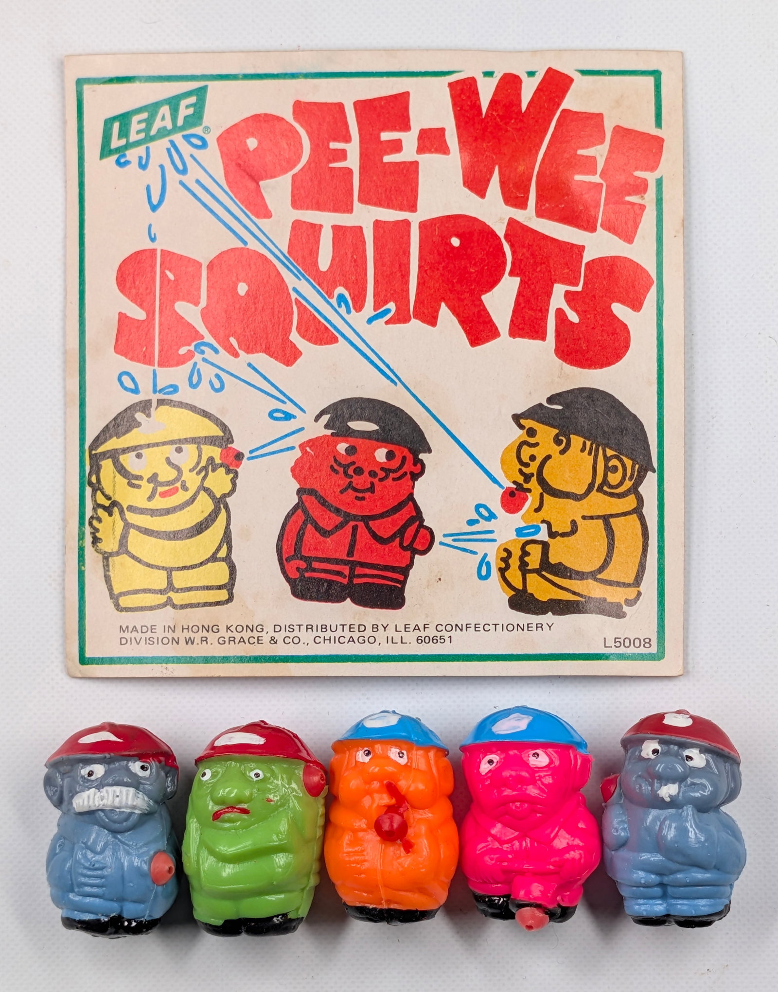 VINTAGE LEAF PEE-WEE SQUIRTS VENDING MACHINE INSERT: REMAINS IN GOOD CONDITION.