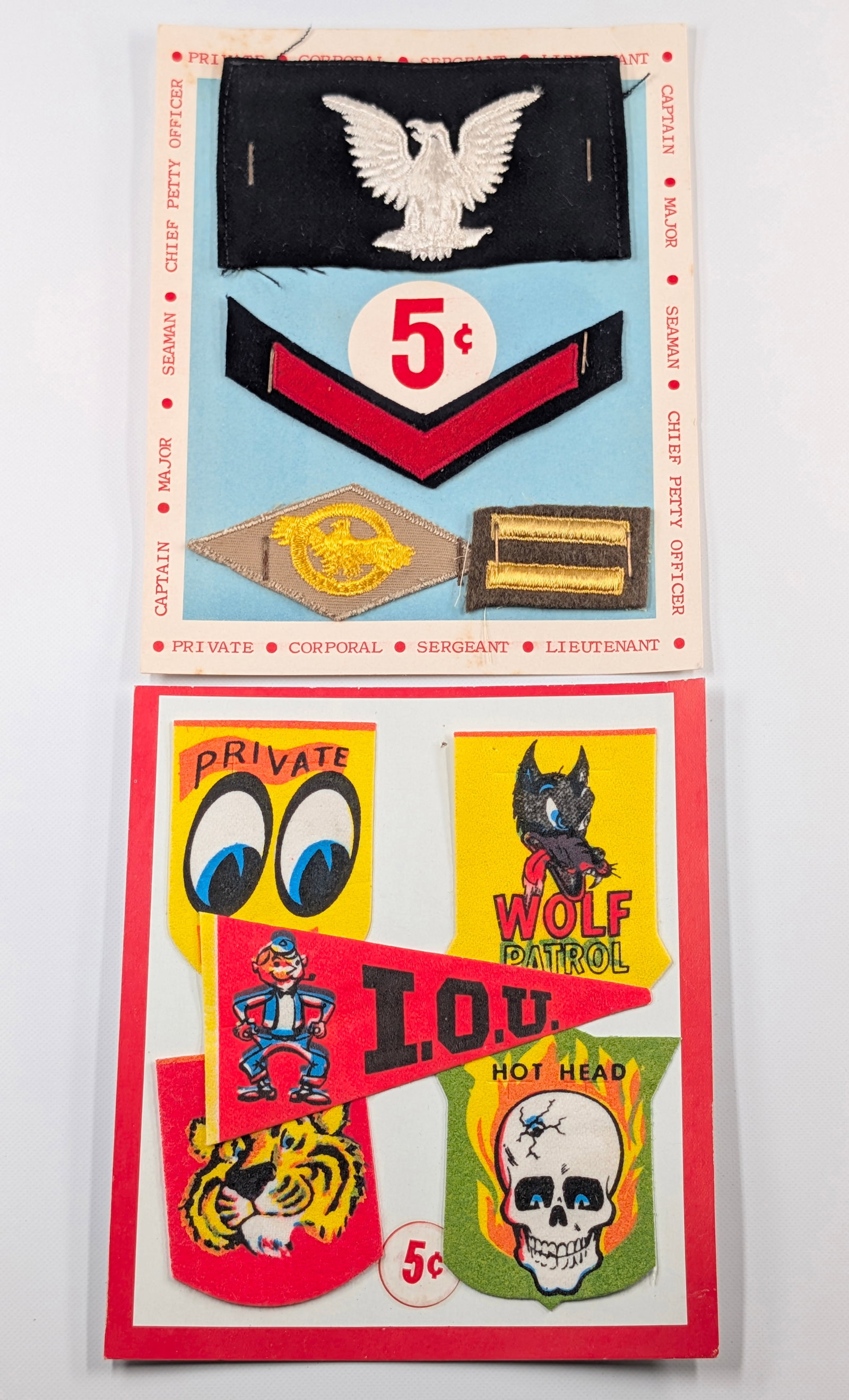 VINTAGE MILITARY PATCHES & COMICAL PATCHES DISPLAYS: BOTH REMAIN IN GOOD CONDITION.