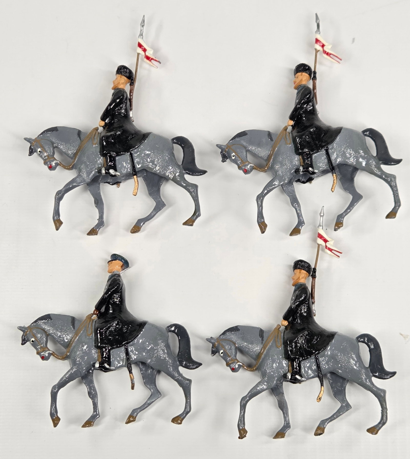 SET OF 4 REPAINTED MOUNTED SOLDIERS: ALL REMAIN IN GOOD CONDITION, SHOWING SOME TYPICAL WEAR.