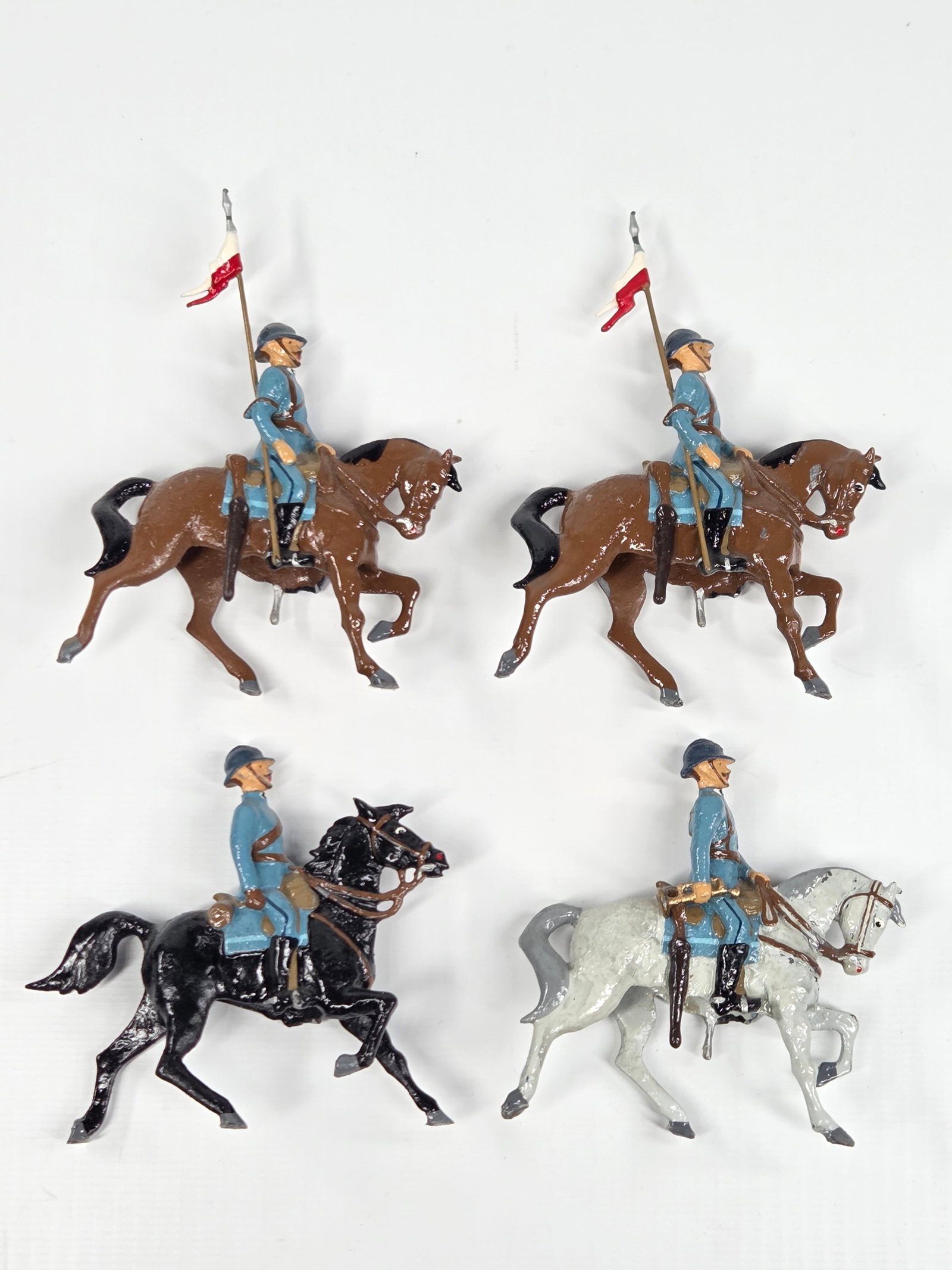 4) UNMARKED HAND PAINTED U.S. CAVALRY MOUNTED: ALL REMAIN IN GOOD CONDITION, SHOWING SOME TYPICAL WEAR.