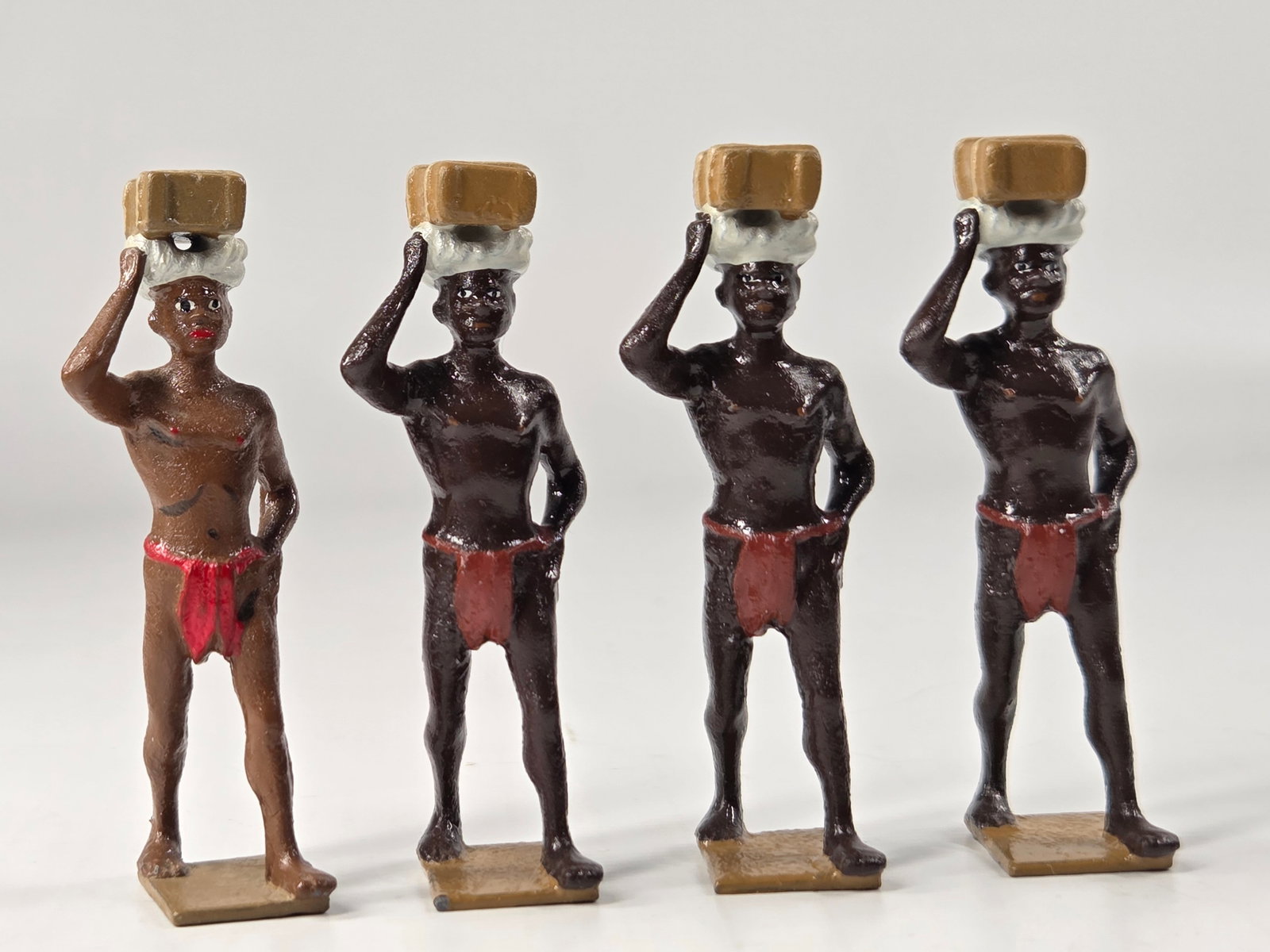 4) HIRIART ELEGUA SOLDIERS: ALL REMAIN IN GOOD CONDITION, SHOWING SOME TYPICAL WEAR.