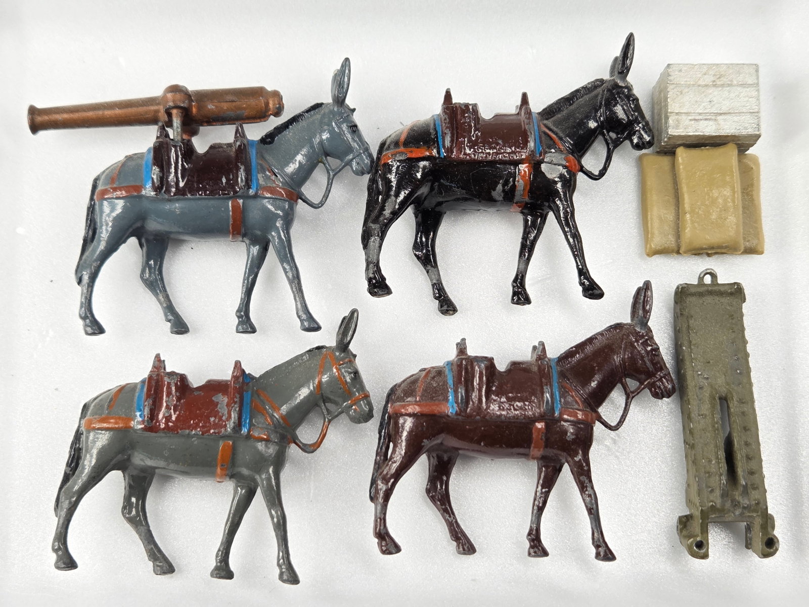 4) LEAD MULE ARTILLERY TEAM: ALL REMAIN IN GOOD CONDITION, SHOWING SOME TYPICAL WEAR.
