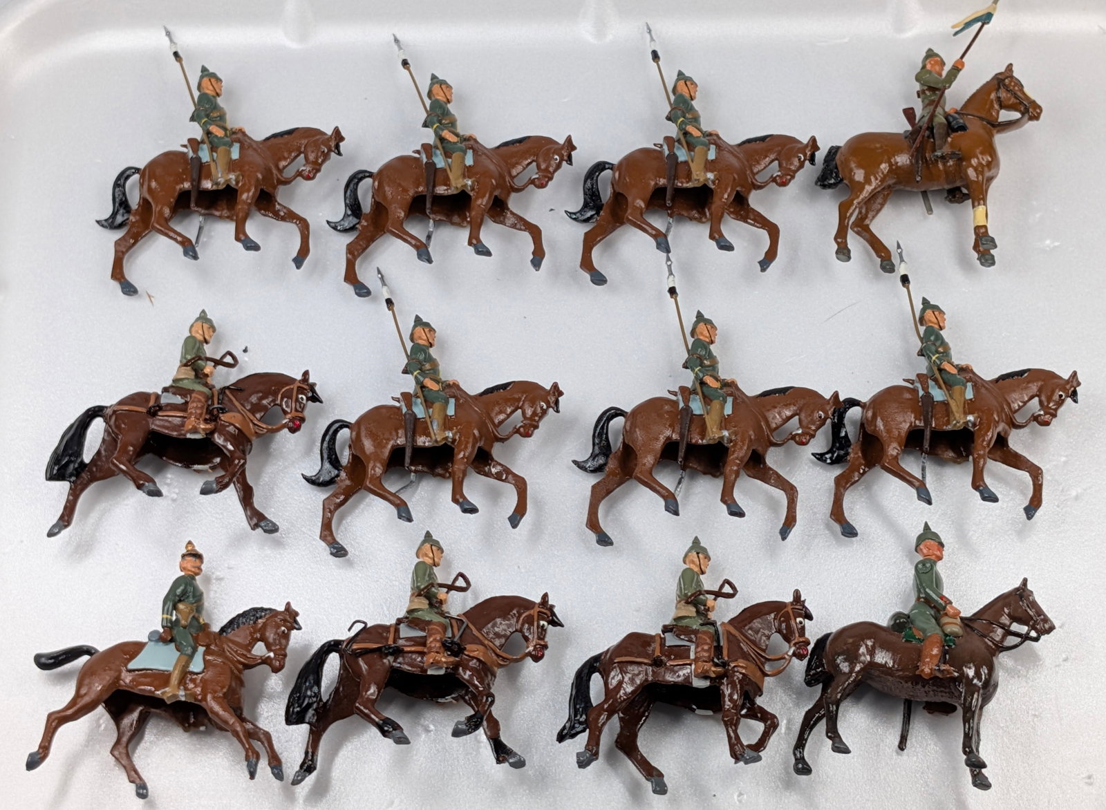 12) UNMARKED HAND PAINTED WWI SOLDIERS MOUNTED: ALL REMAIN IN FAIR TO GOOD CONDITION, SHOWING SOME TYPICAL WEAR.
