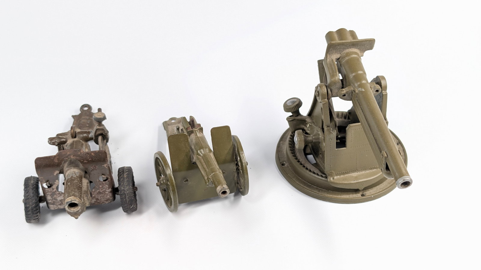 3) VINTAGE LEAD MILITARY CANNONS: ALL REMAIN IN FAIR TO GOOD CONDITION, SHOWING SOME TYPICAL WEAR. DUSTY, NEEDING CLEANED.