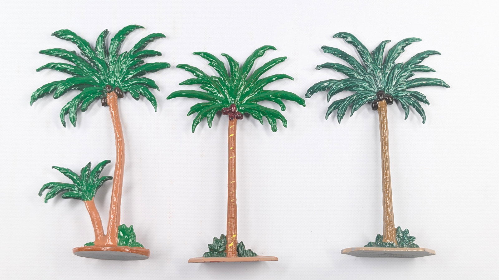 3) UNMARKED HAND PAINTED LEAD PALM TREES: ALL REMAIN IN GOOD CLEAN CONDITION, SHOWING SOME MINIMAL PAINT WEAR.