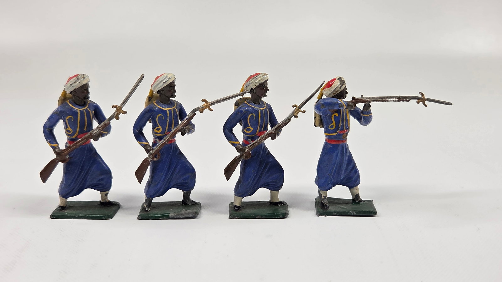 SET OF 4 HAND PAINTED FRENCH ZOUAVES: ALL REMAIN IN GOOD CONDITION, SHOWING PAINT WEAR.