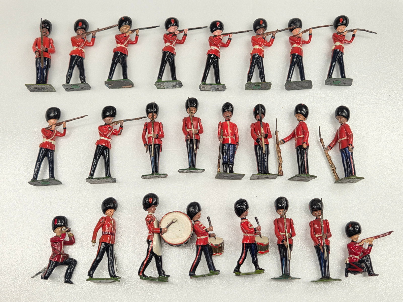 24) VINTAGE BRITAIN COLDSTREAM GUARDS: ALL REMAIN IN FAIR TO GOOD CONDITION, SHOWING SOME TYPICAL WEAR.