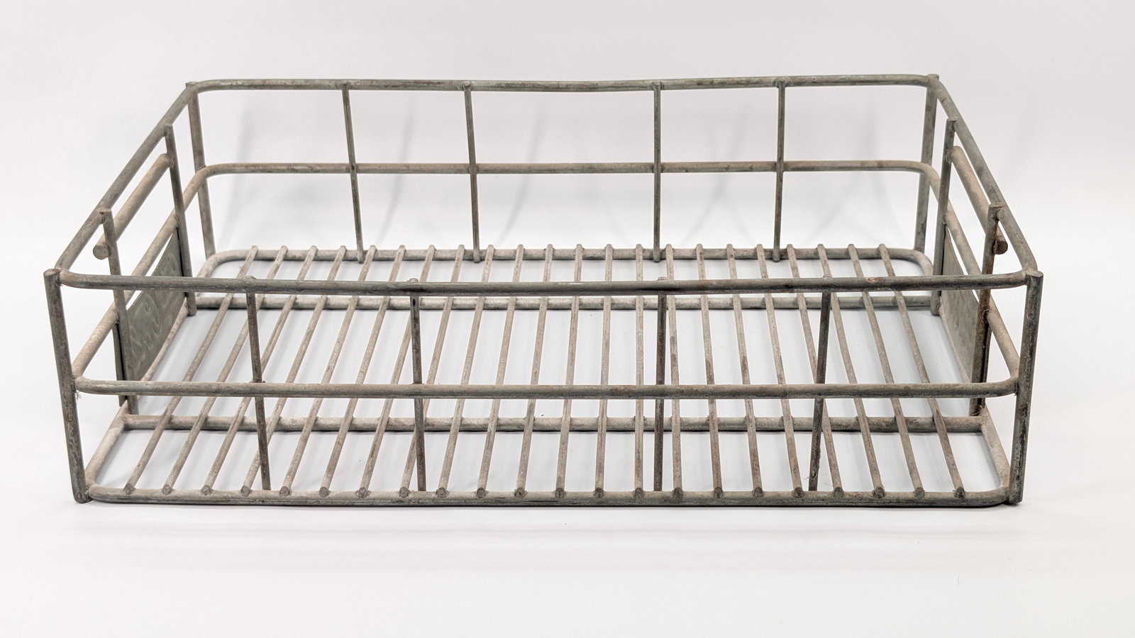 METAL COCA COLA SODA BOTTLE TRAY INSERT: REMAINS IN FAIR TO GOOD CONDITION, SHOWING SOME TYPICAL WEAR.