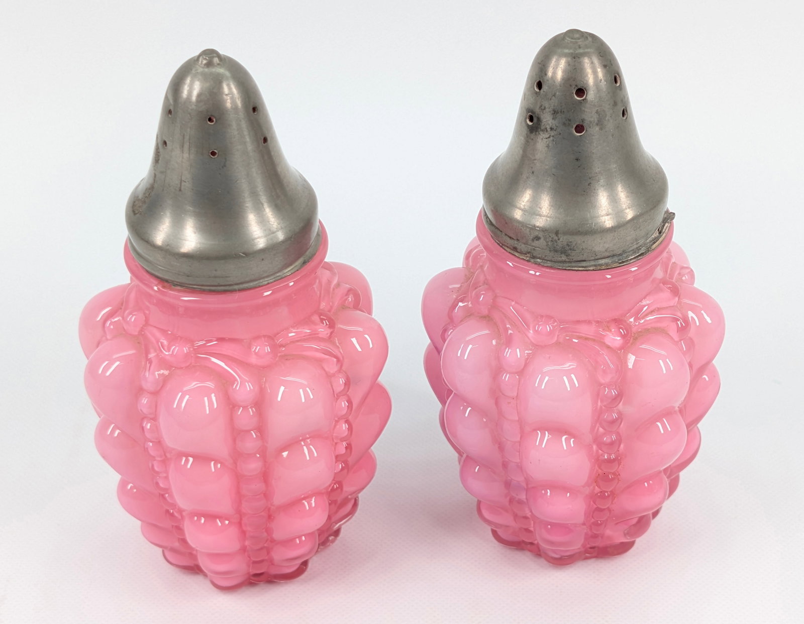 ANTIQUE CONSOLIDATED GLASS CO. PINK GUTTATE SALT & PEPPER SET: SET REMAINS IN GOOD CONDITION, SHOWING SOME TYPICAL USAGE WEAR.