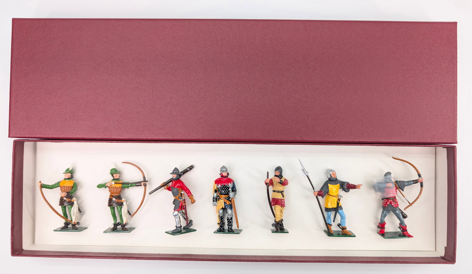 FUSILIER MINIATURES 7-PIECE ARCHER SET: ALL REMAIN IN GOOD CONDITION, SHOWING SOME LIGHT WEAR. CUSTOM BOX.