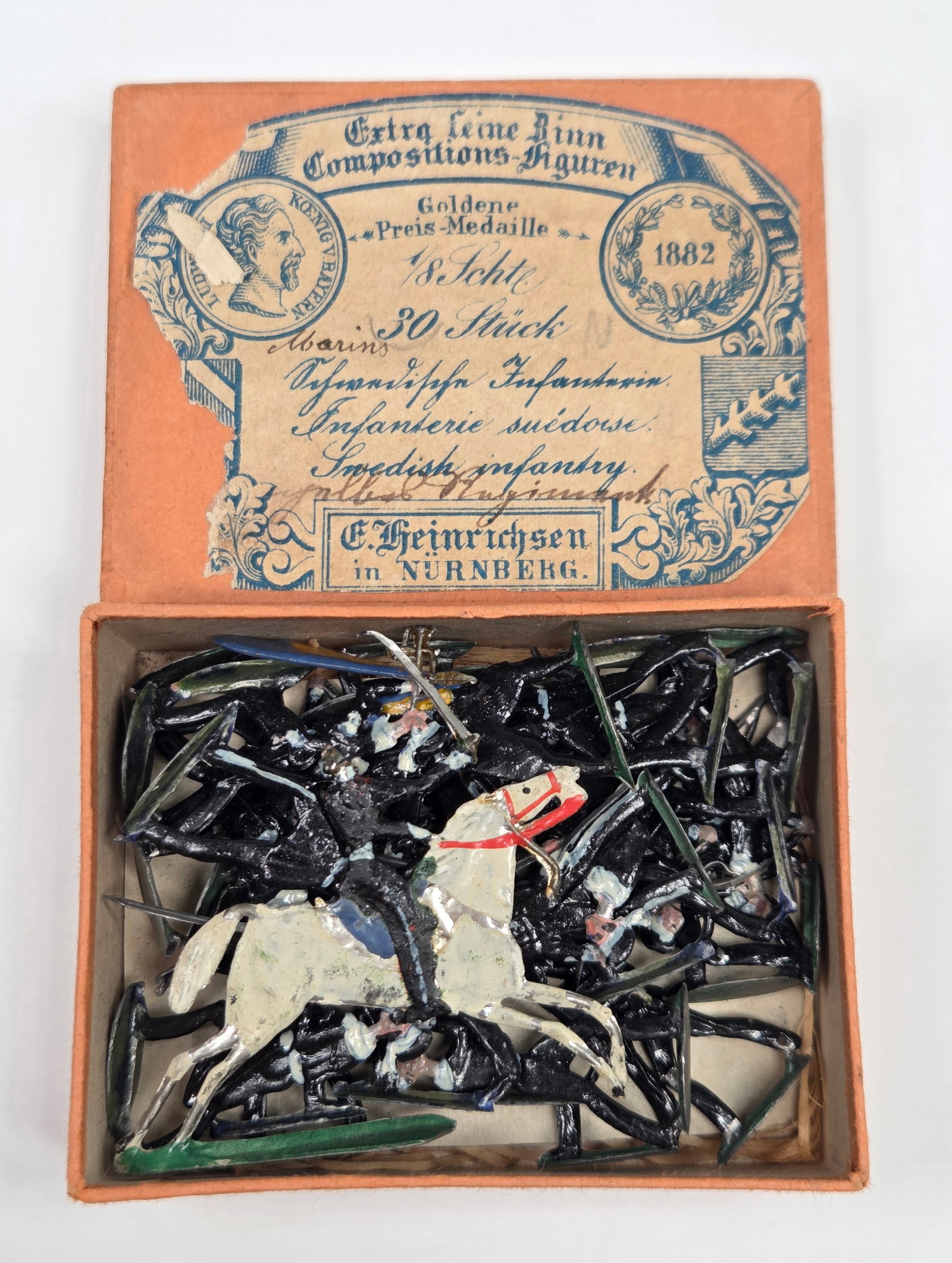 ANTIQUE ERNST HEINRICHSEN GERMAN FLAT SOLDIERS W/ BOX: ALL REMAIN IN FAIR TO GOOD CONDITION, SHOWING SOME LIGHT TYPICAL WEAR. ORIGINAL BOX REMAINS IN FAIR TO GOOD CONDITION, SHOWING STORAGE WEAR.