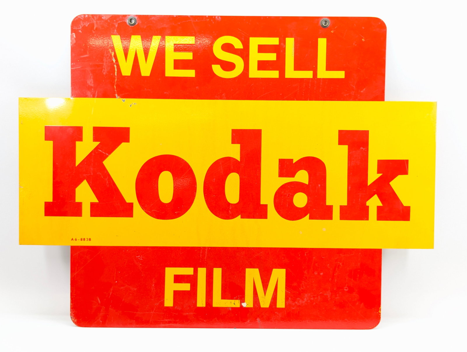 WE SELL KODAK FILM HANGING METAL SIGN: REMAINS IN GOOD CONDITION, SHOWING SOME LIGHT SCUFFS / SCRATCHES.