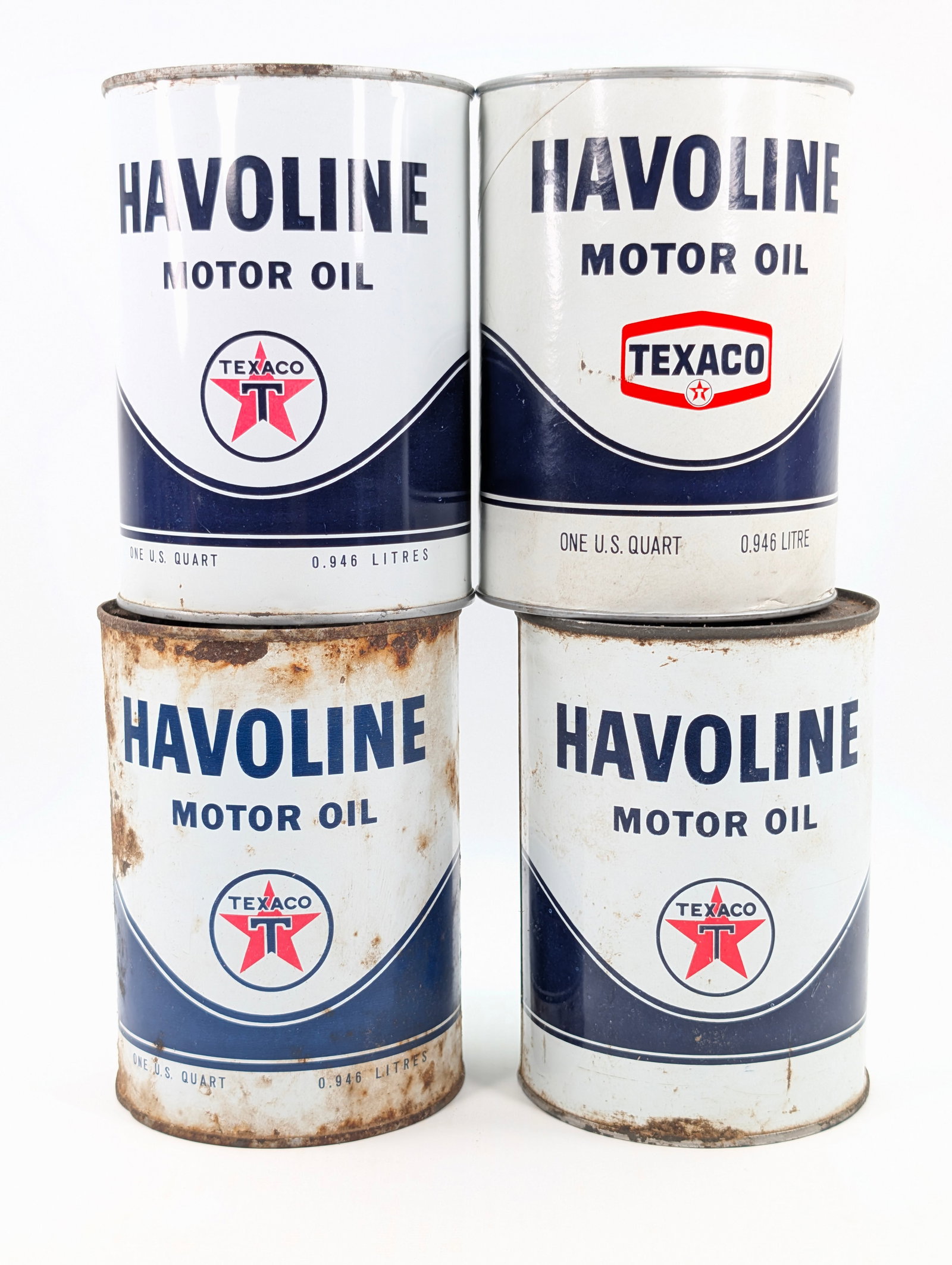 4) TEXACO HAVOLINE MOTOR OIL ONE US QUART CANS: 3) METAL 1) CARDBOARD. ONE OF THE METAL SHOWING WEAR THROUGHOUT. ALL OTHERS REMAIN IN GOOD CONDITION, SHOWING SOME LIGHT TYPICAL WEAR.