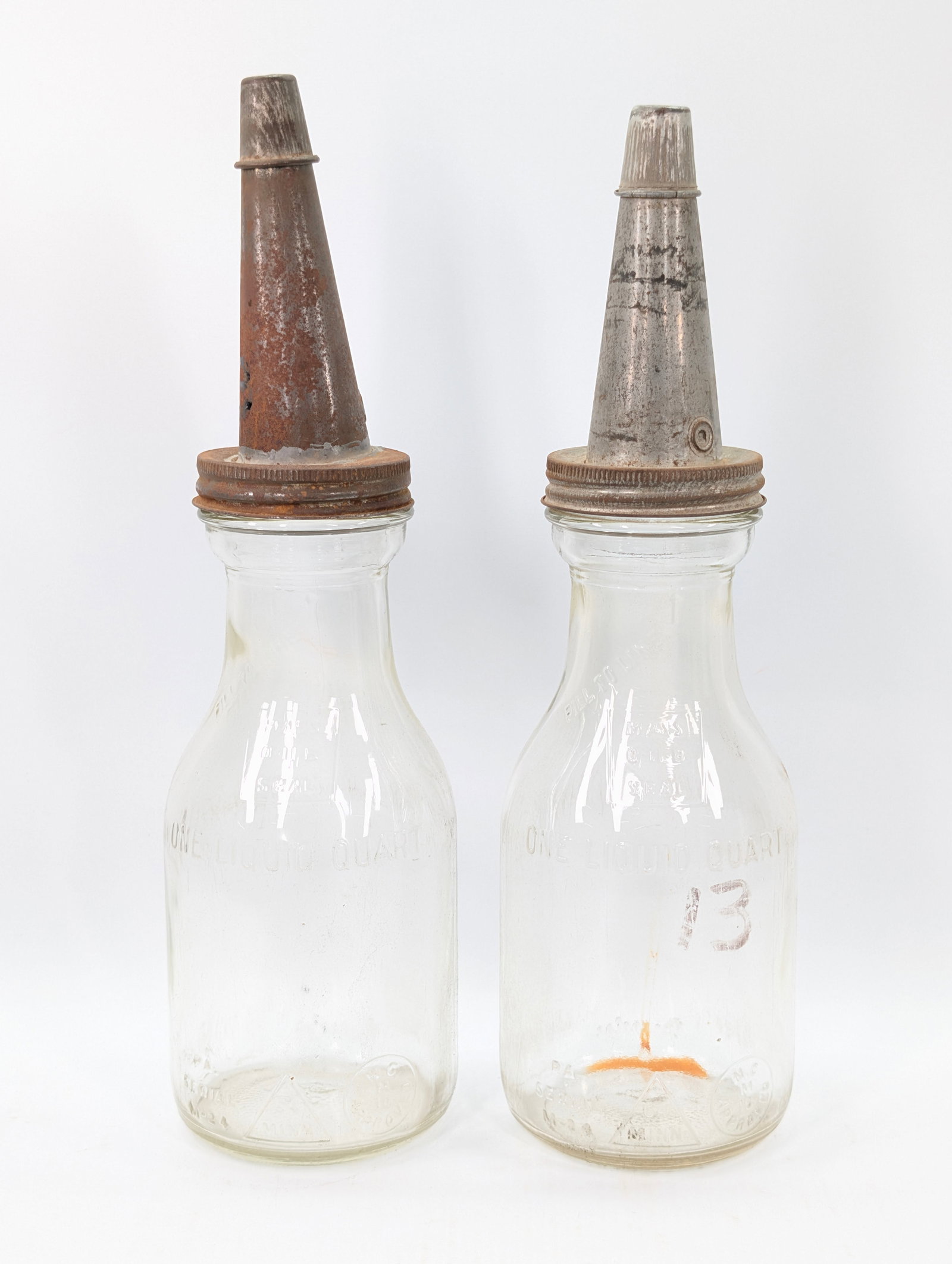 2) ANTIQUE GLASS ONE QUART MOTOR OIL BOTTLES: BOTH REMAIN IN GOOD CONDITION, SHOWING TYPICAL USAGE WEAR. BOTH NEED CLEANED.