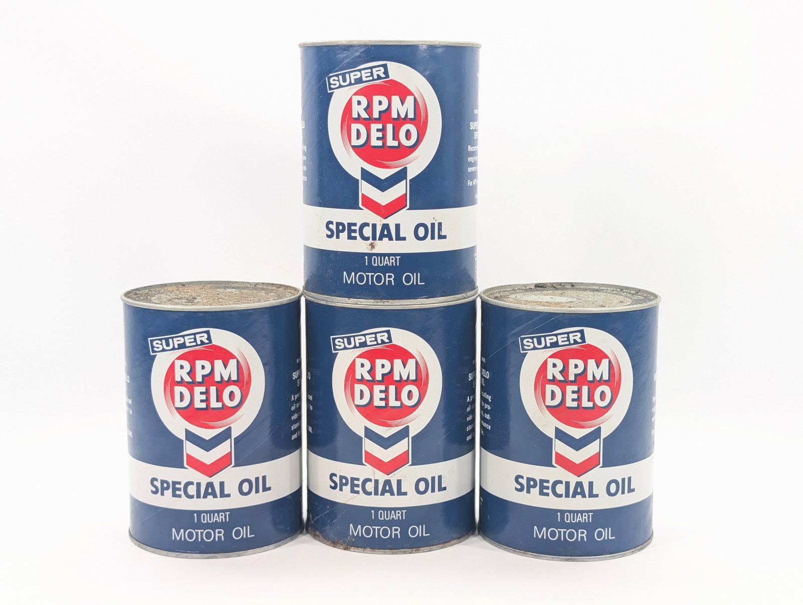 4) SUPER RPM DELO ONE QUART MOTOR OIL CANS UNOPENED: CARDBOARD CANS ALL REMAIN IN GOOD UNOPENED CONDITION. DIRTY, NEEDING CLEANED.