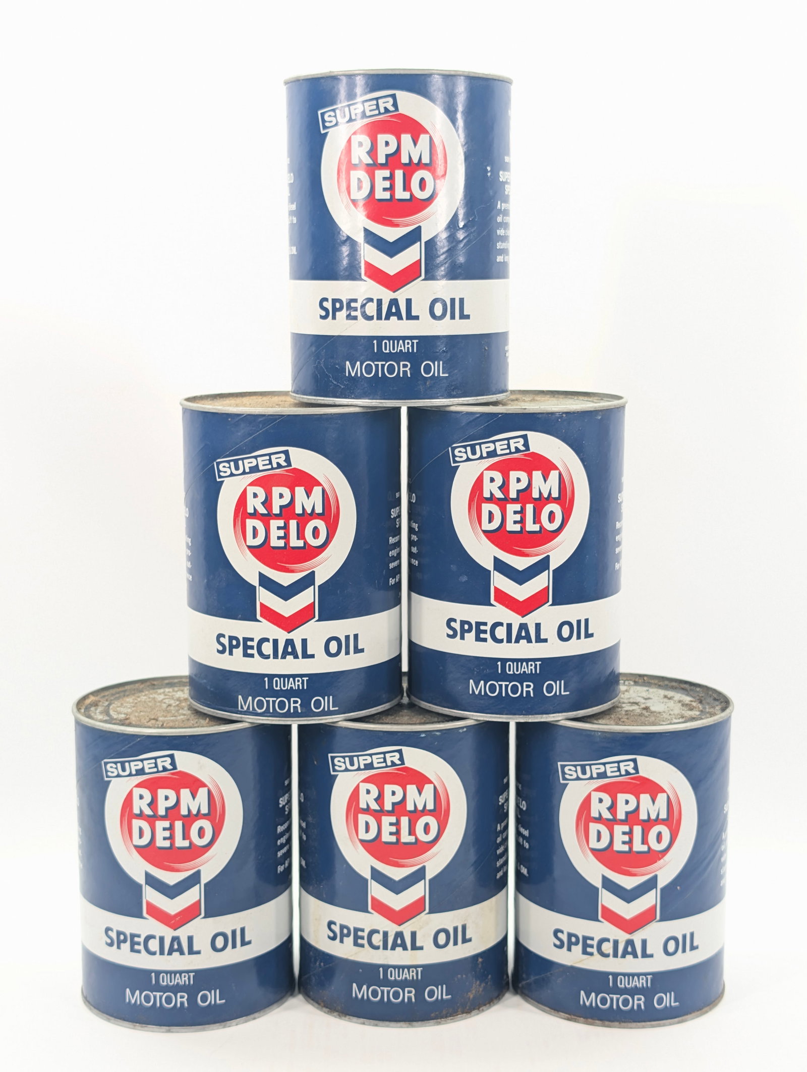 6) SUPER RPM DELO ONE QUART MOTOR OIL CANS UNOPENED: CARDBOARD CANS ALL REMAIN IN GOOD UNOPENED CONDITION. DIRTY, NEEDING CLEANED.